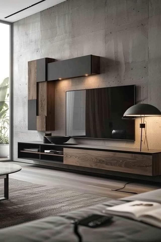 Modern living room with wall-mounted flat-screen TV, wooden and black storage units, a black bowl, a black and white lamp, and large window with curtains.