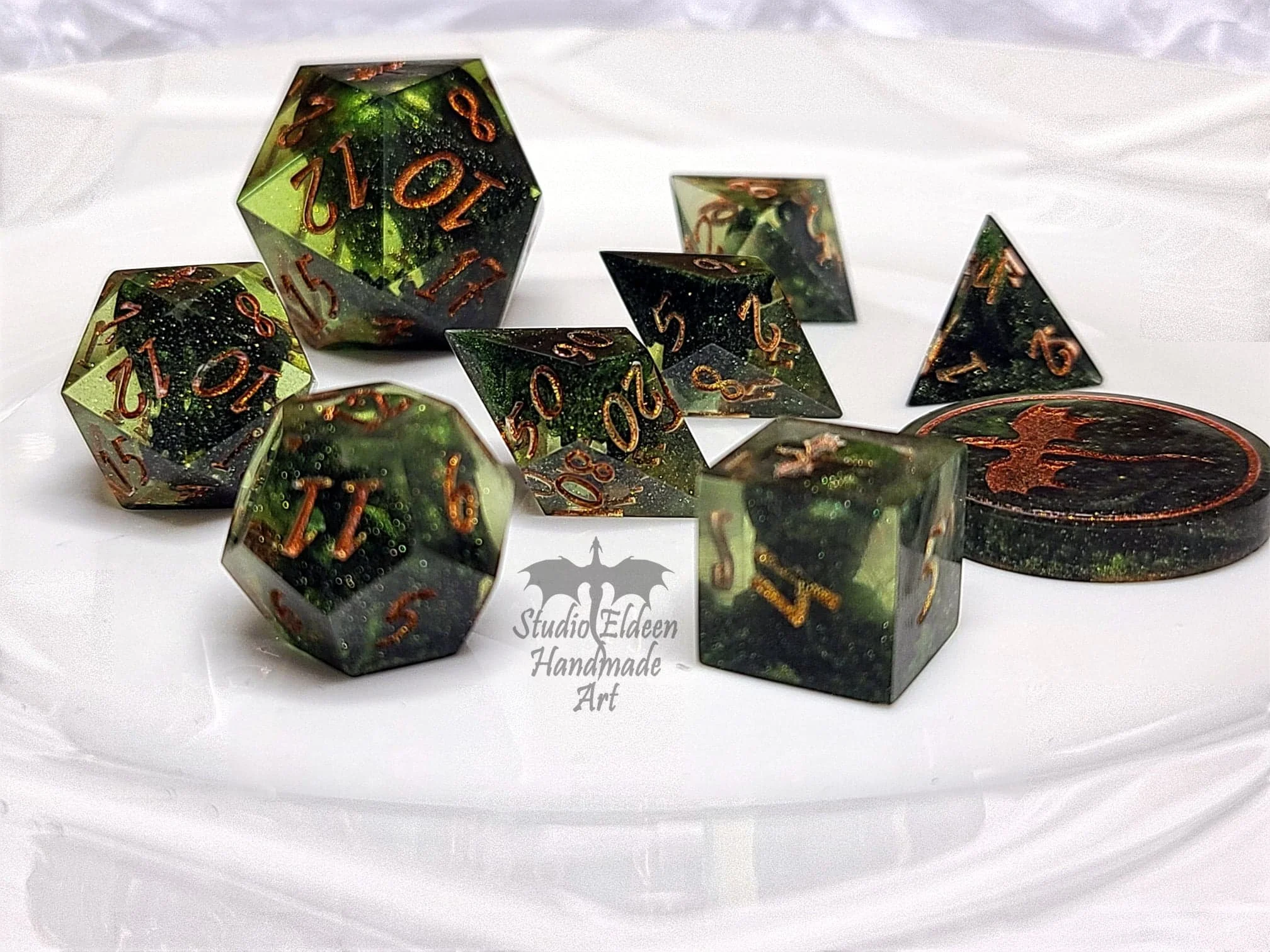 A fun, oozy green set of dice for my DM, inked in bronze.