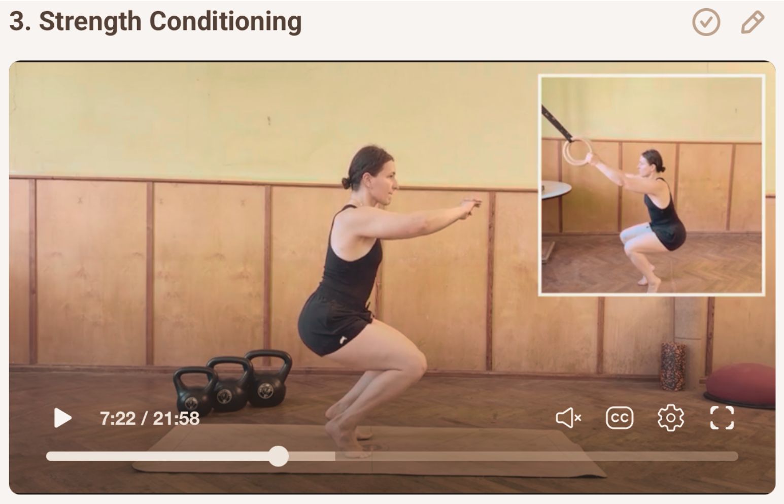A woman performs squat exercises in a gym, with kettlebells on the floor beside her. An inset shows her holding gymnastic rings while squatting.