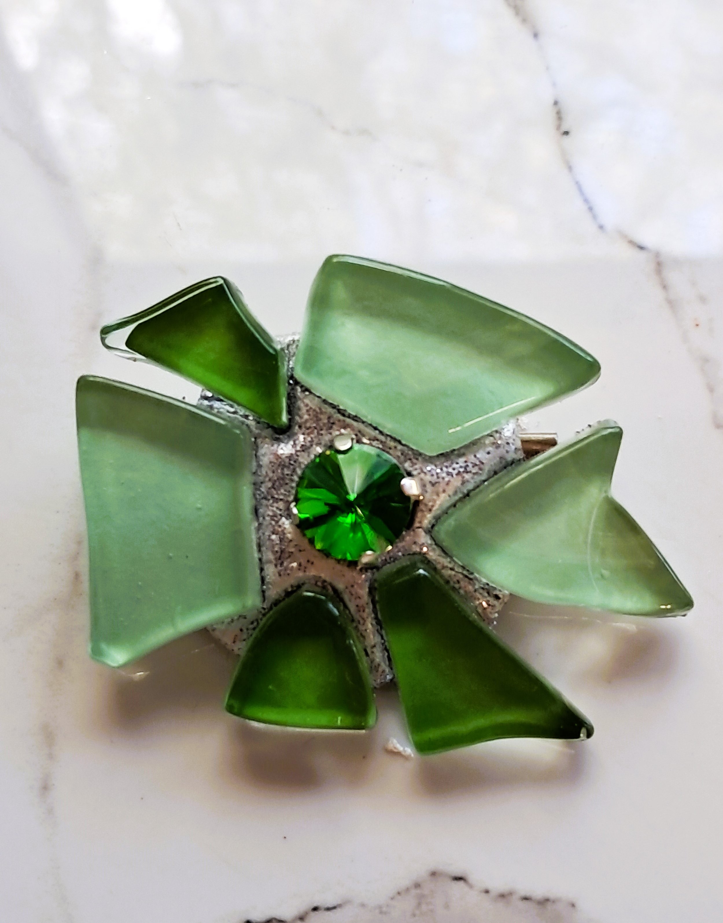 Mosaic brooch. in green glass with dark green crystal. made by the brooch place