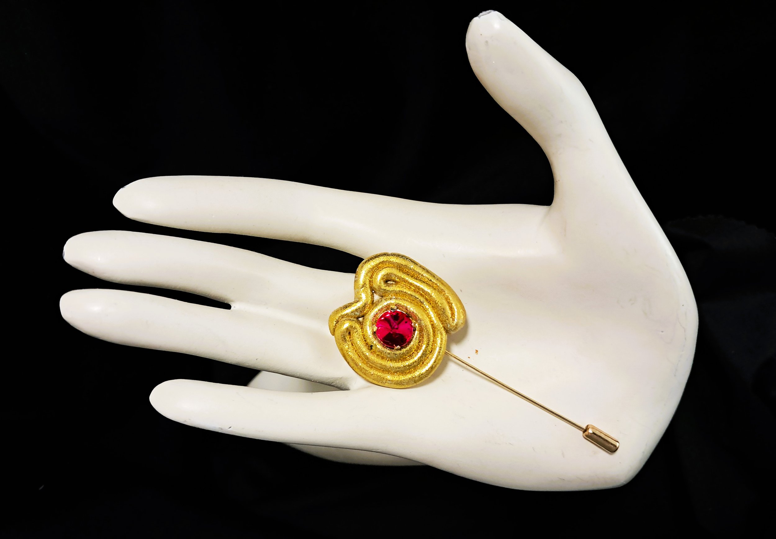 pink swirl pin hand.jpg