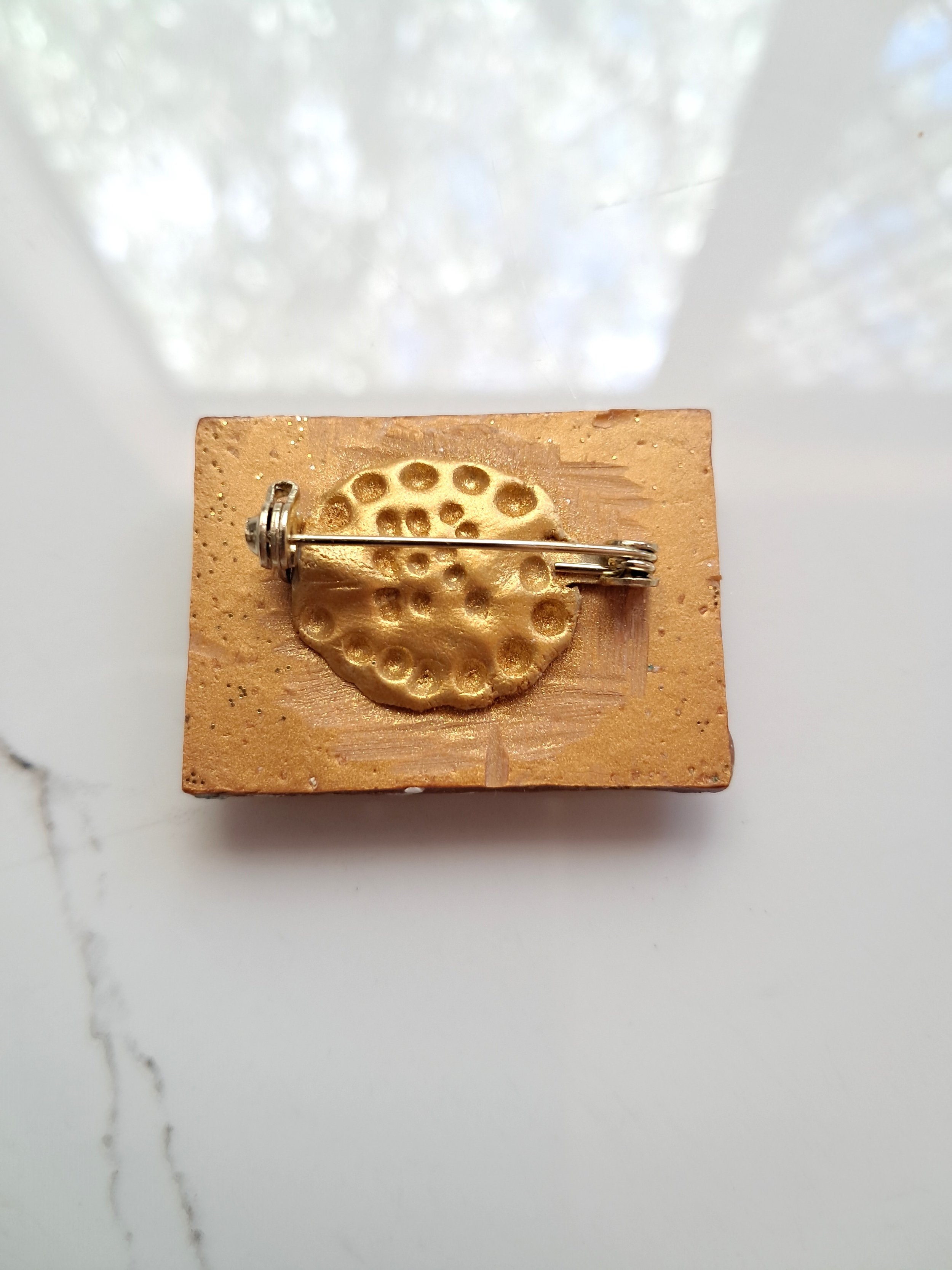 Golden eye brooch back.jpg