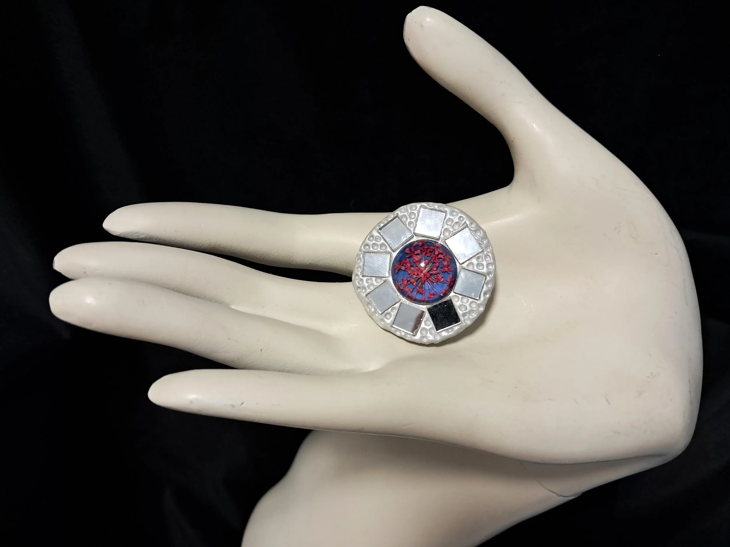 glass shield brooch pink hand.jpg