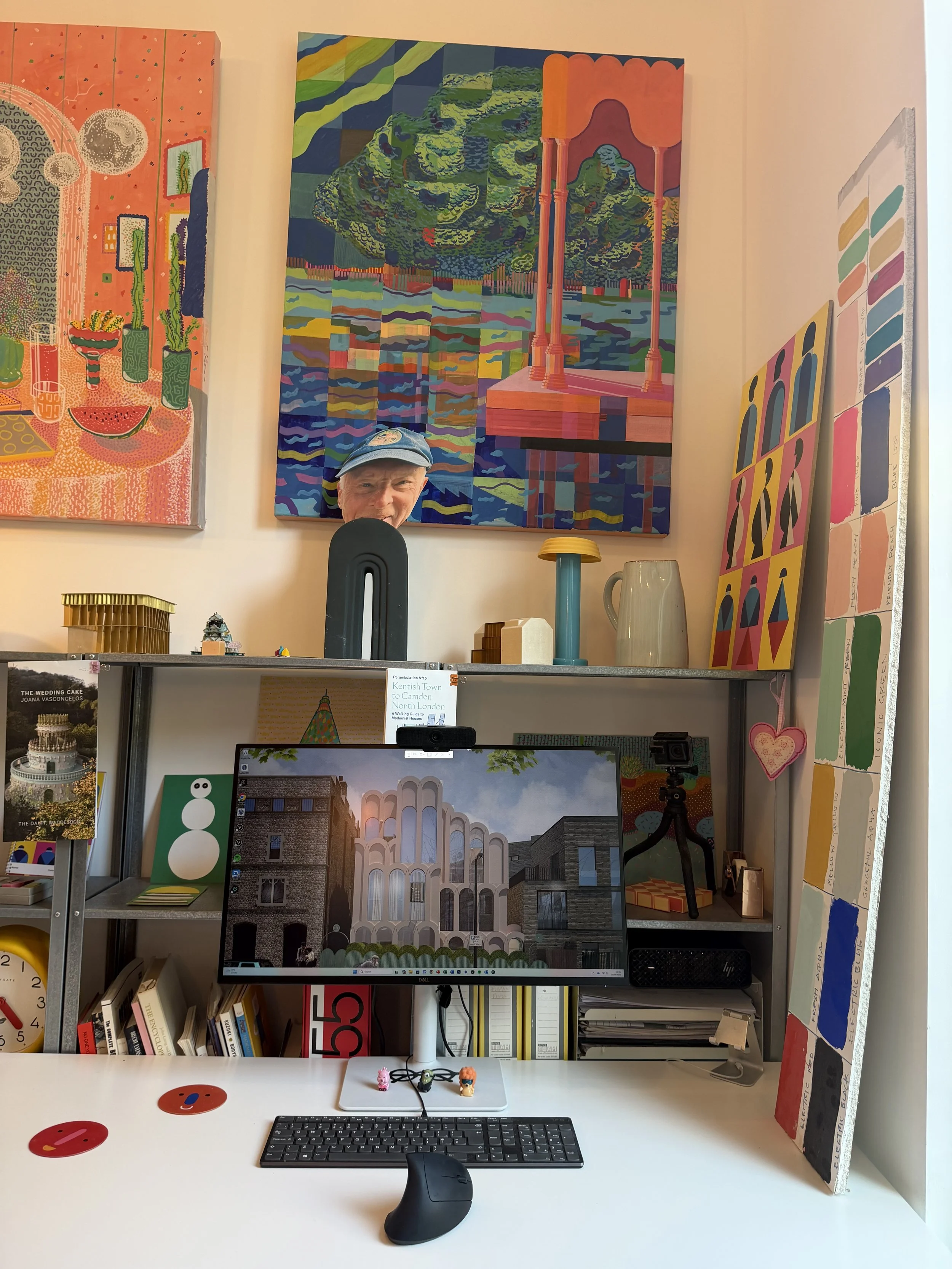 Colourful interior workspace inside Cloud House, surrounded by artwork and architectural models