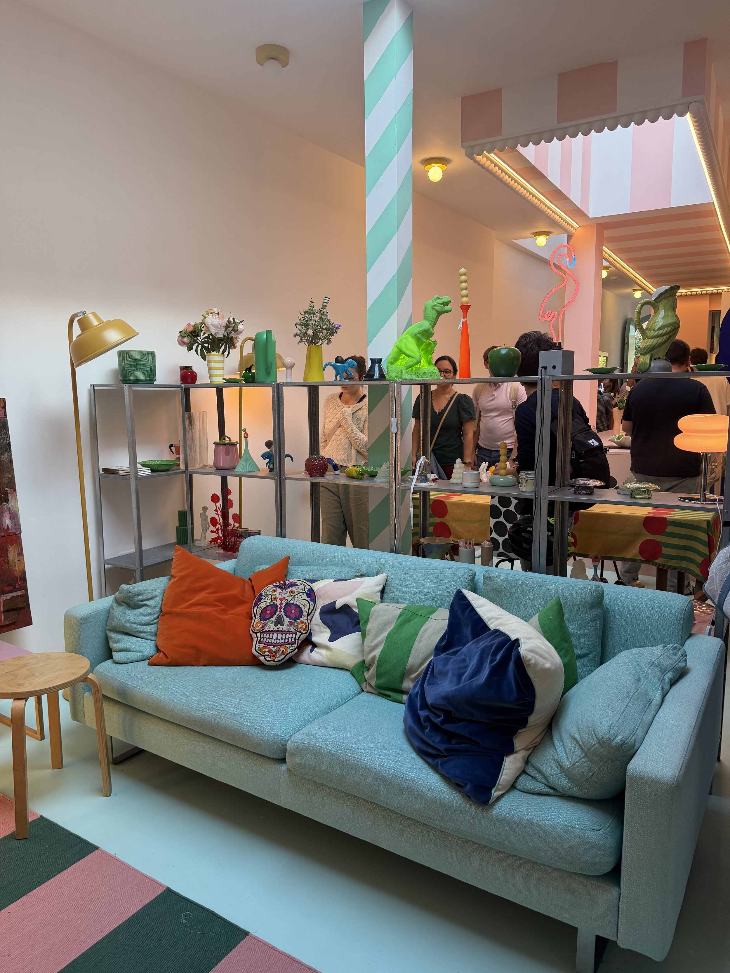 Colourful living area inside Cloud House with a turquoise sofa, sculptural objects and playful interior details