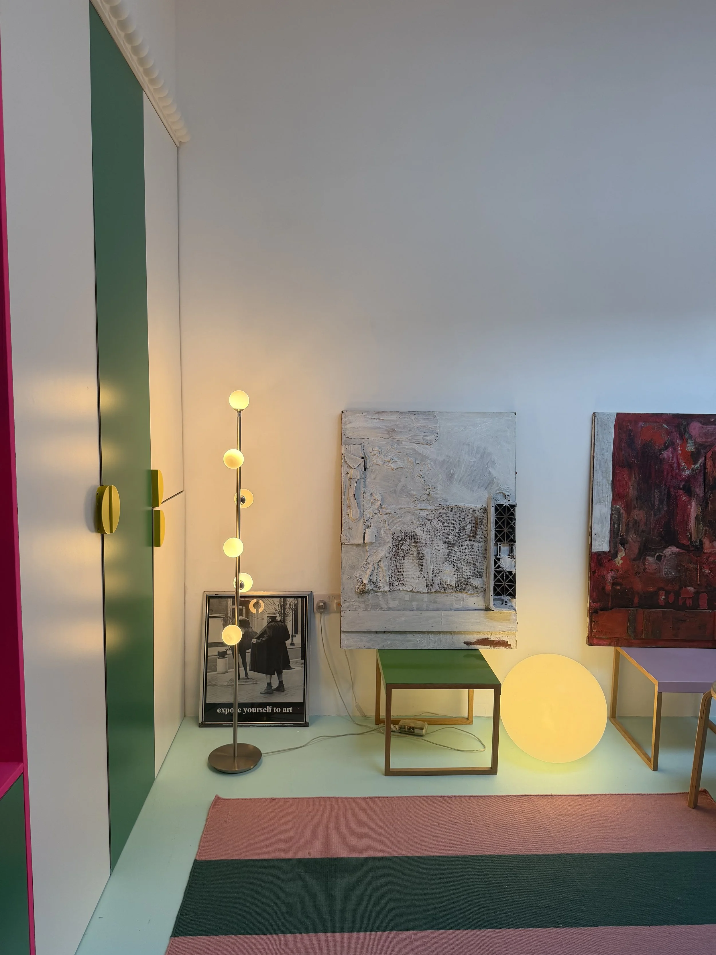 Contemporary artwork and sculptural lighting inside the colourful interior of Cloud House in North London