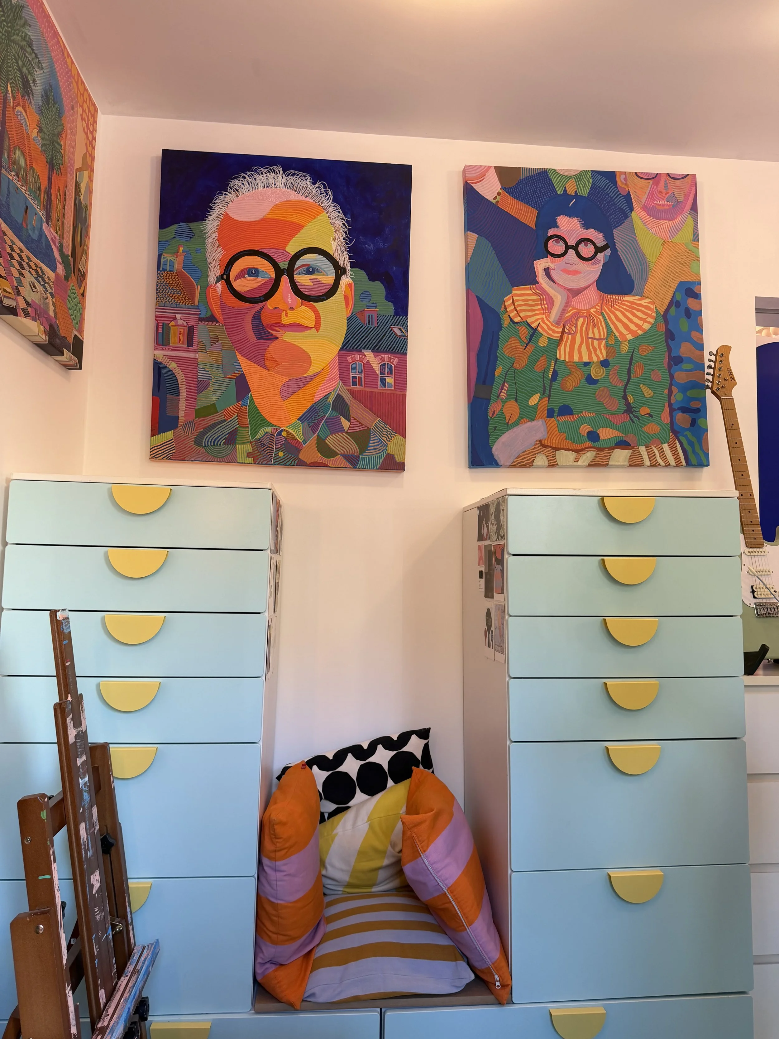 Colourful artwork and bespoke blue storage cabinets inside Cloud House in Gospel Oak, North London