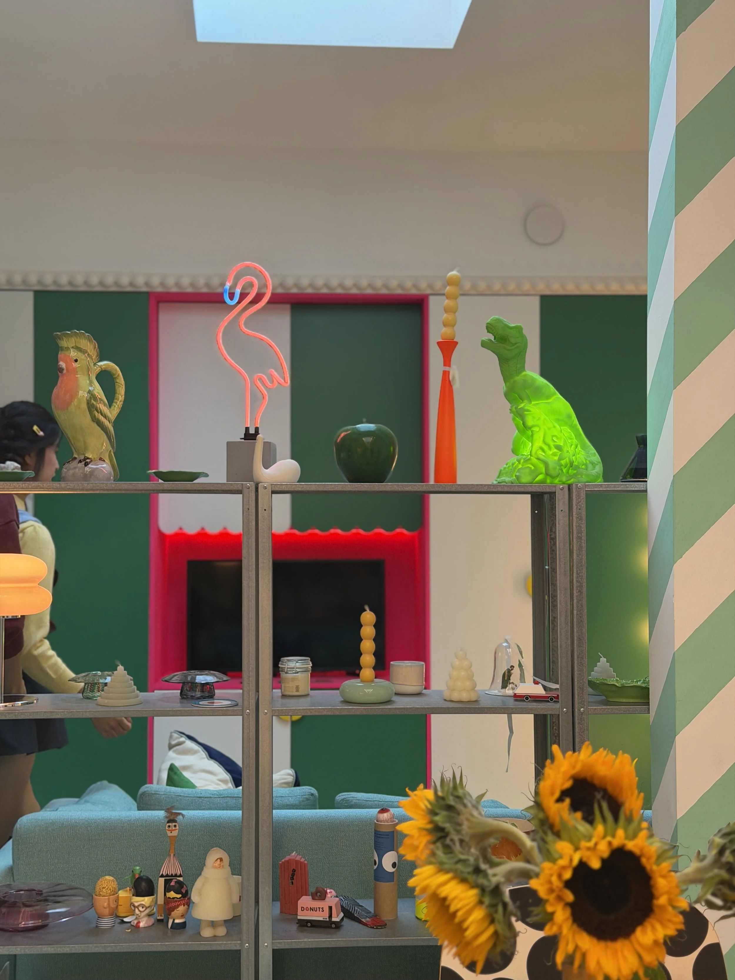 Eclectic interior of Cloud House with colourful objects, sculptural ceramics and a neon flamingo light