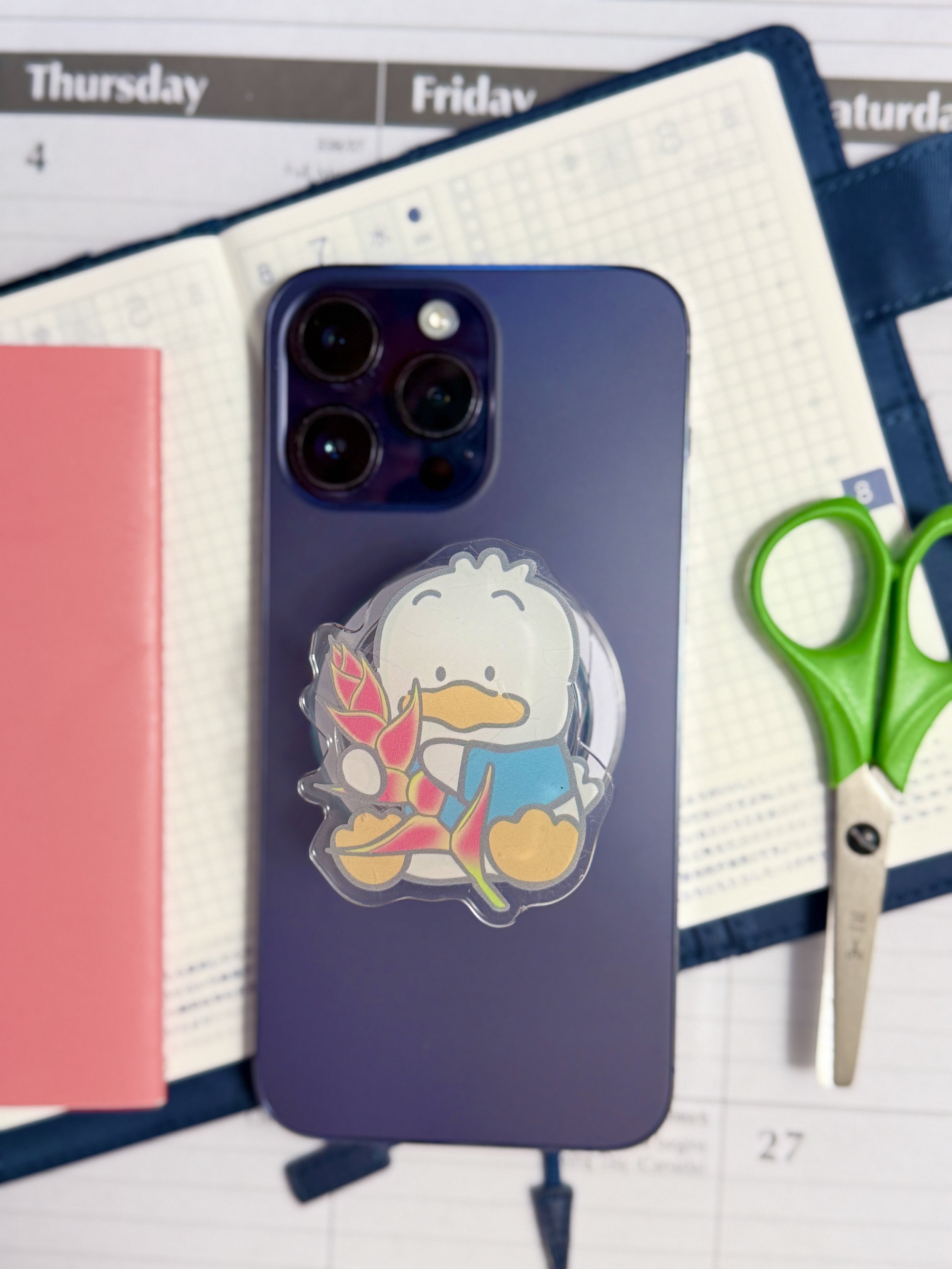 Sitting Pekkle x Heliconia Phone Grip