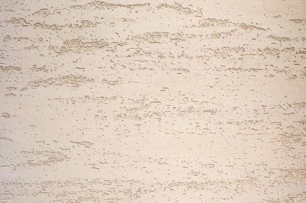 CASTELLO travertine stone coating sample, open pitted texture in Travertine White — Elf Decor · CASTELLO ground travertine coating sample, banded stone effect in Warm Beige — Elf Decor