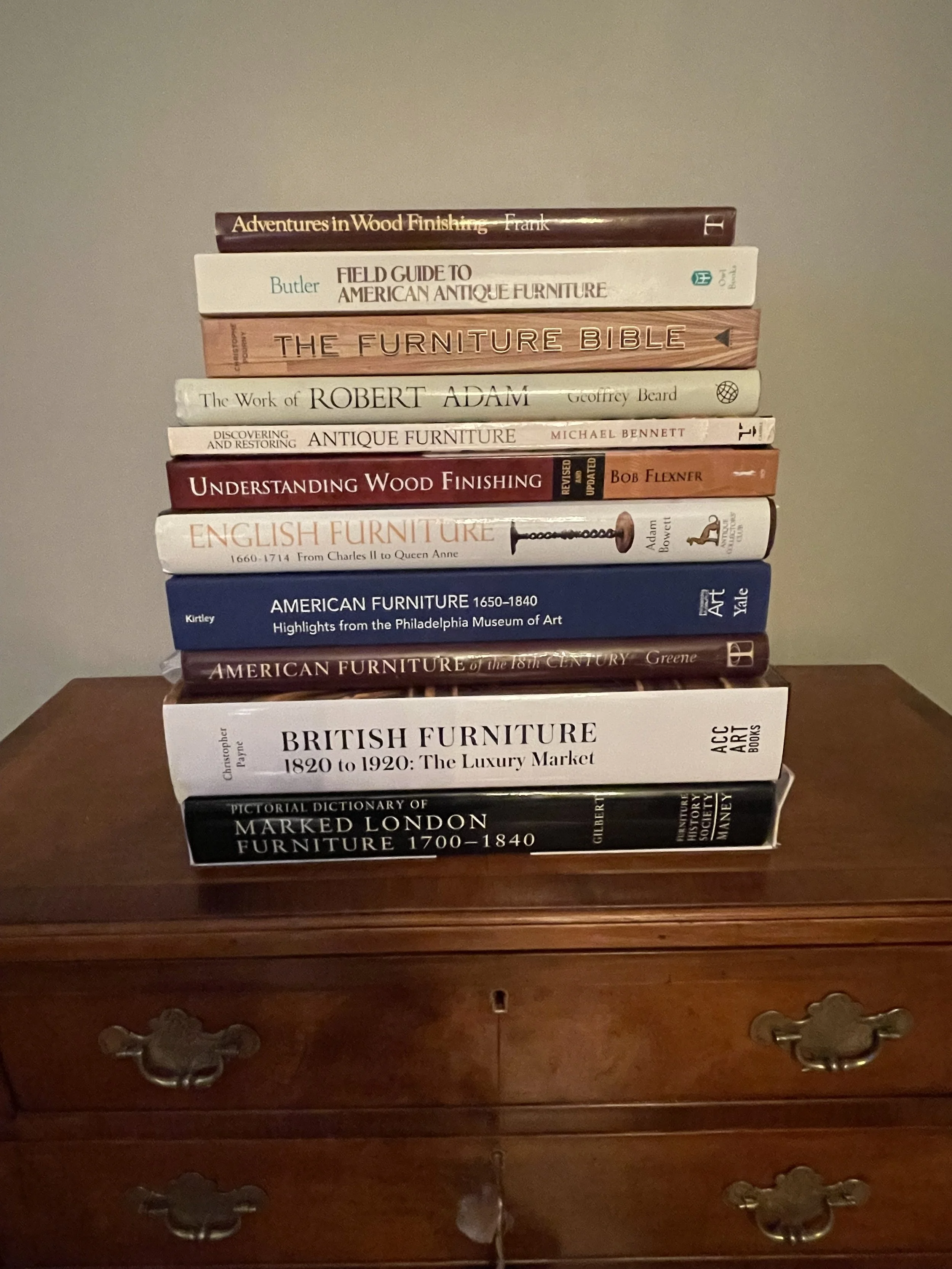 A stack of books on the history of furniture and restoration