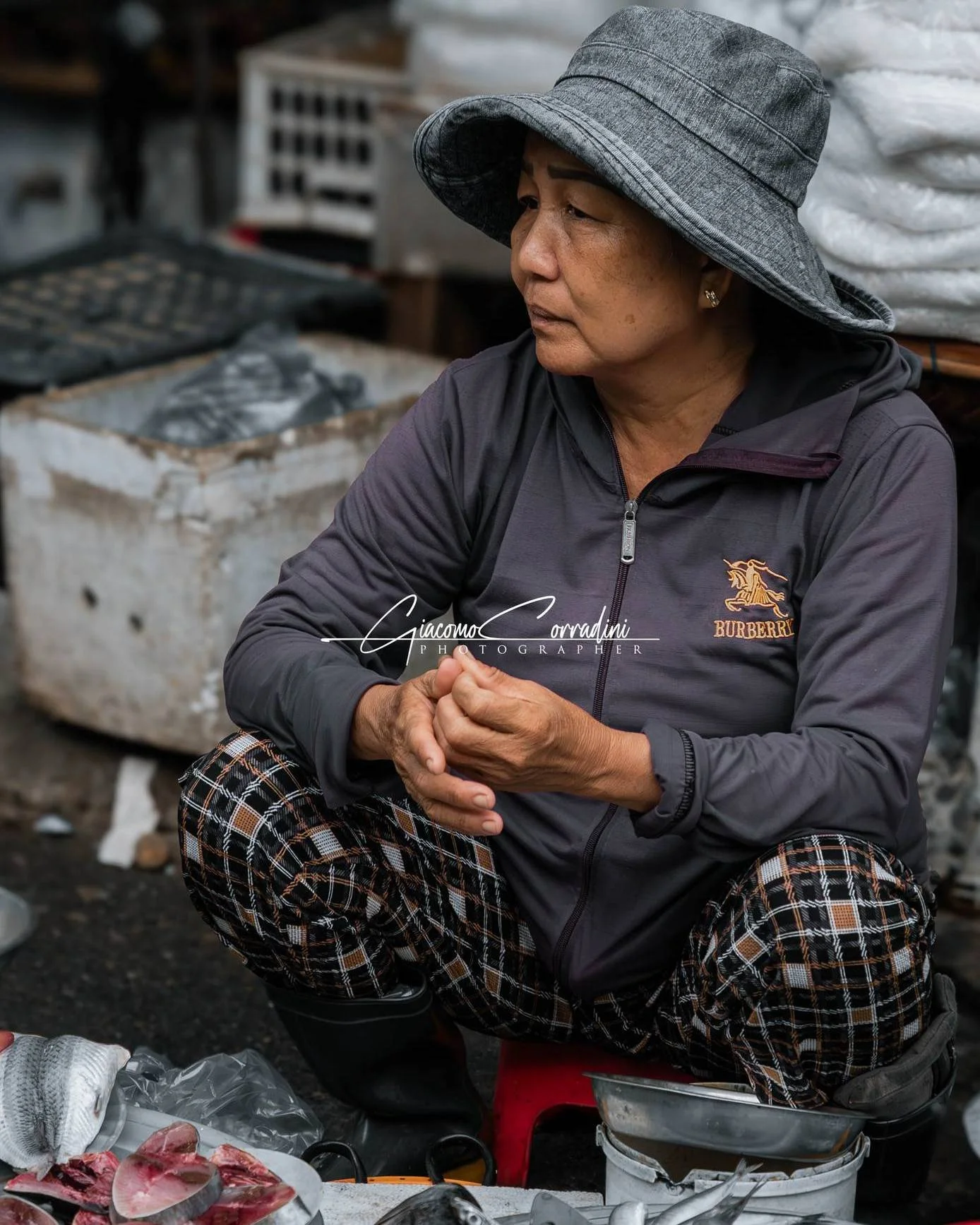 Venditrice seduta a terra accanto alla sua merce, Hanoi Vietnam Wild Travel Films