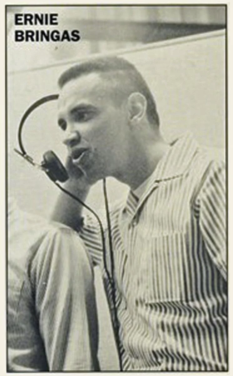 Marketing black-and-white photograph of Ernie Bringas singing into a microphone