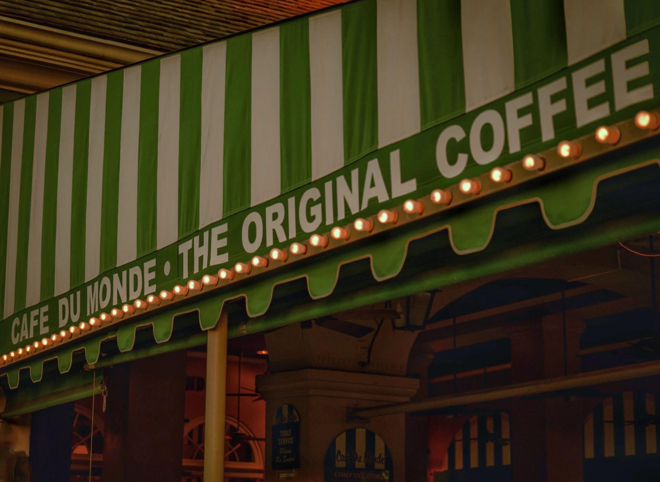 Nighttime view of Cafe du Monde awning with lights