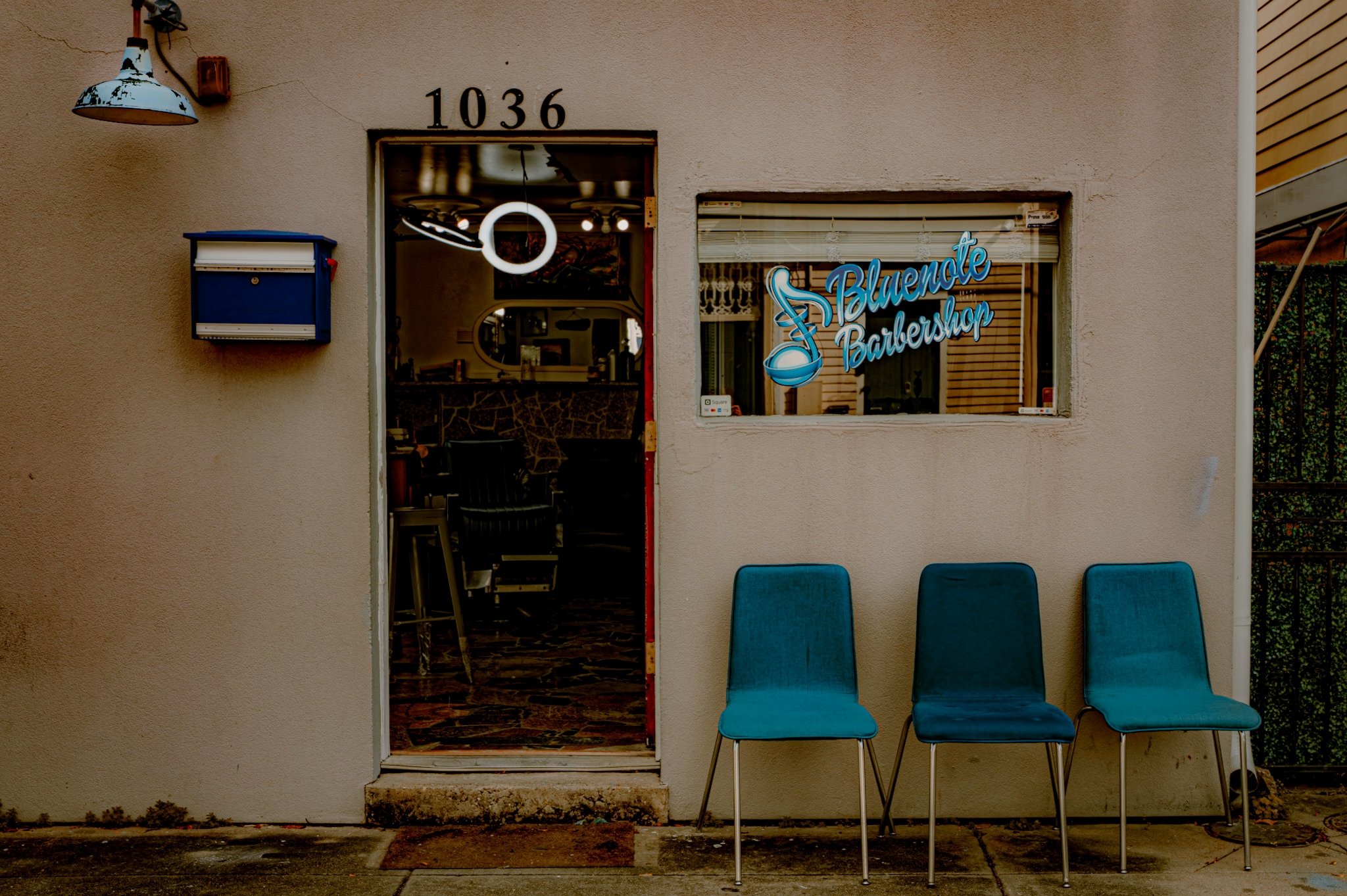 Blue Note Barbershop with 3 Blue Chairs lined up in Treme