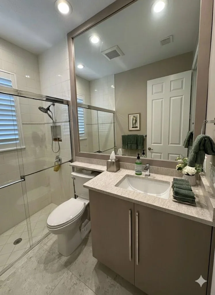 Example how modern materials, clean lines and a neutral palette can transform a dated guest bathroom into a sophisticated, spa-inspired space that feels both inviting and timeless.