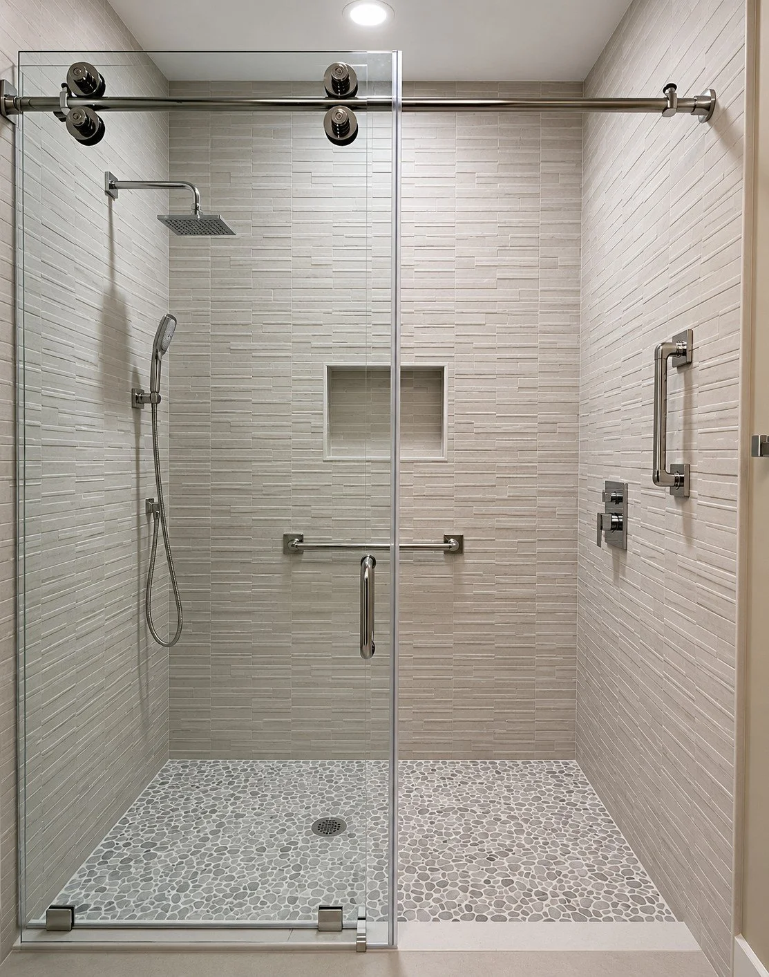 The soft neutral-toned walk-in shower blends comfort, safety and contemporary elegance. Proof that designing for safety and comfort does not have to compromise high-end design.