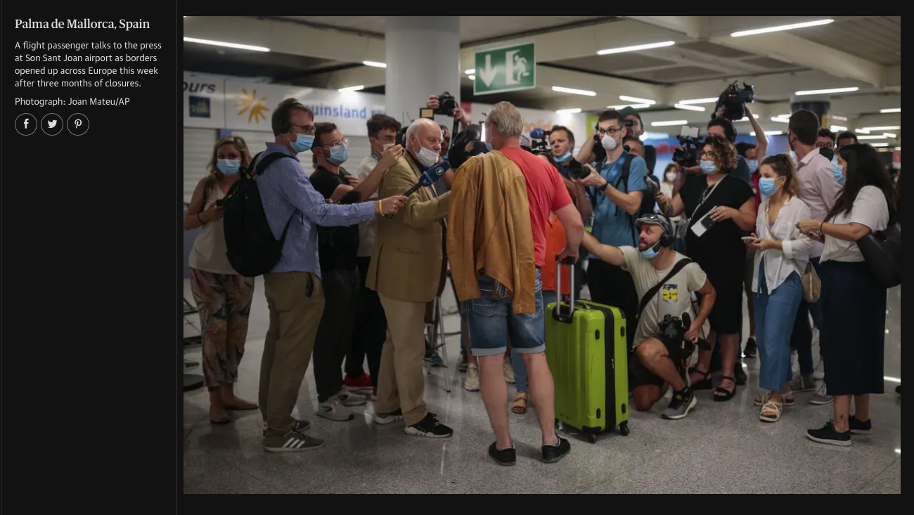 A man with a yellow blazer and white mask is being interviewed by the press at Palma de Mallorca airport. Several journalists with cameras and microphones gather around him, all wearing masks. The scene occurs indoors at an airport with a sign indica