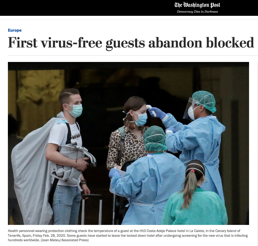 Health personnel in protective clothing checking the temperature of a guest at a hotel hotel in Tenerife, Spain, during the COVID-19 pandemic in February 2020.