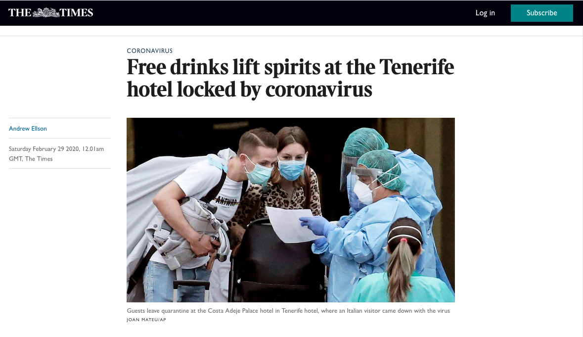 Guests wearing masks at a quarantine check-in counter with healthcare workers dressed in protective gear at a Tenerife hotel during the coronavirus lockdown.