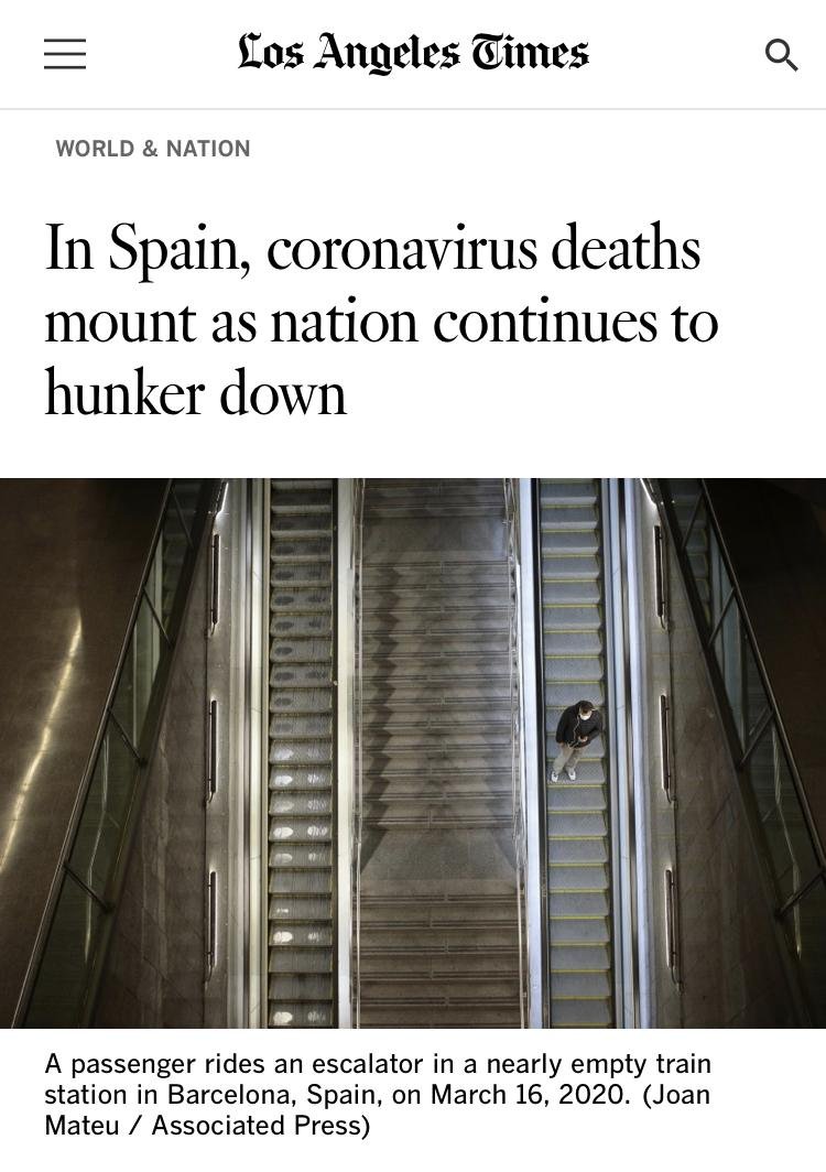 A passenger rides an escalator in a nearly empty train station in Barcelona, Spain, on March 16, 2020.