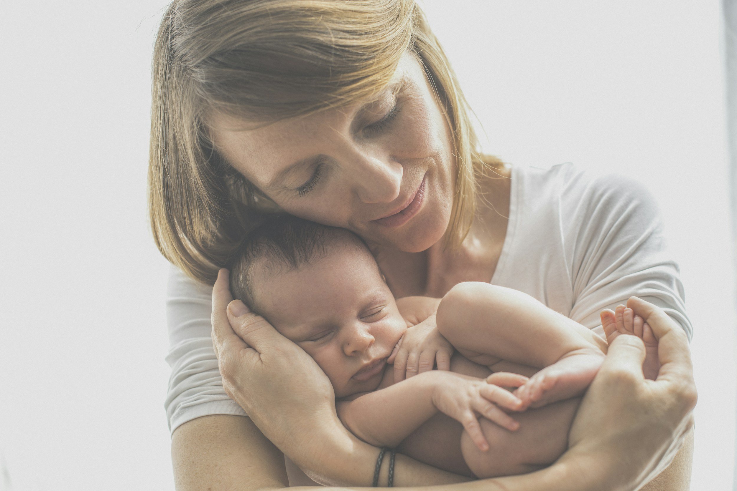 postpartum joy holding baby