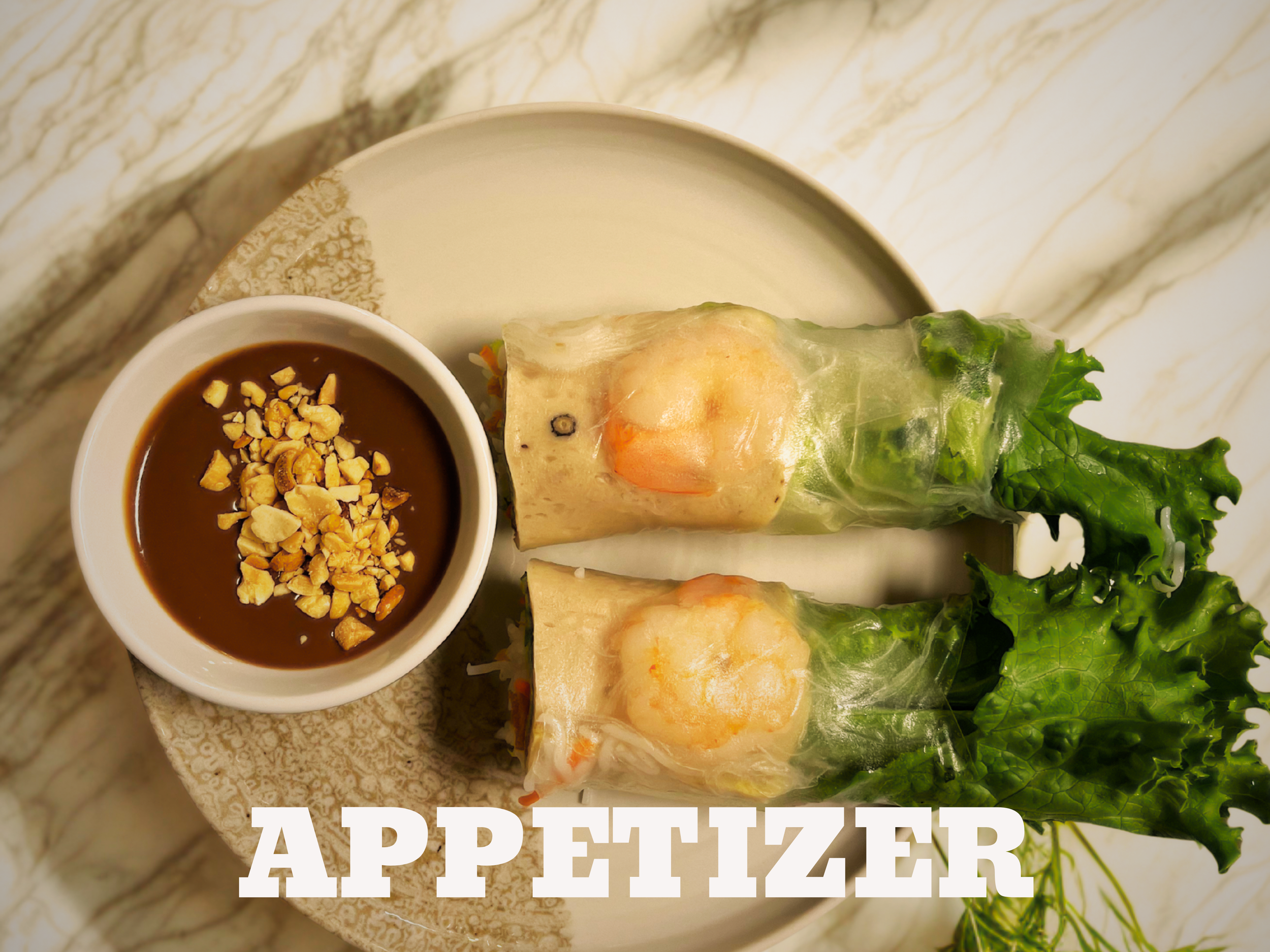 Two Vietnamese spring rolls with shrimp and vegetables on a white plate, accompanied by a small bowl of dipping sauce topped with chopped peanuts.