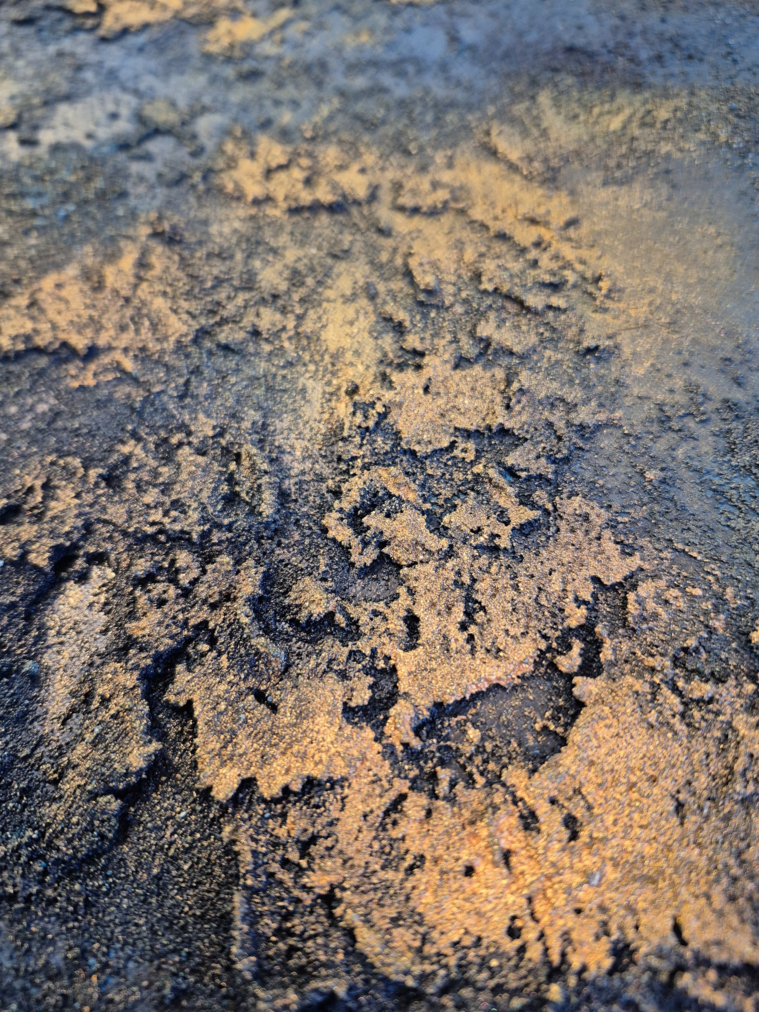 Large 1-meter circular abstract painting featuring deep indigo and navy blue textures with raised metallic gold leaf accents, styled in a modern Scandinavian bedroom.