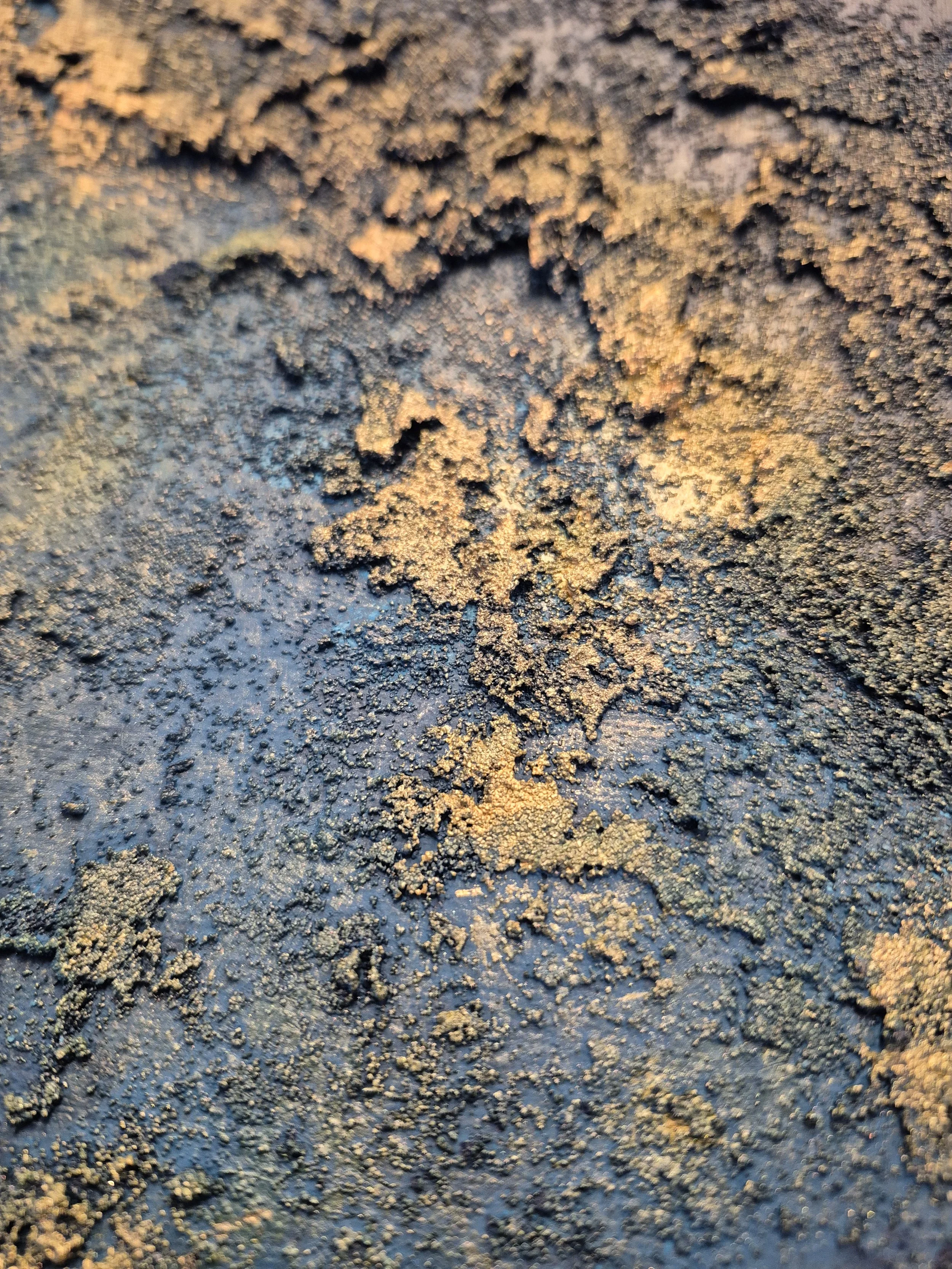 Large 1-meter circular abstract painting featuring deep indigo and navy blue textures with raised metallic gold leaf accents, styled in a modern Scandinavian bedroom.