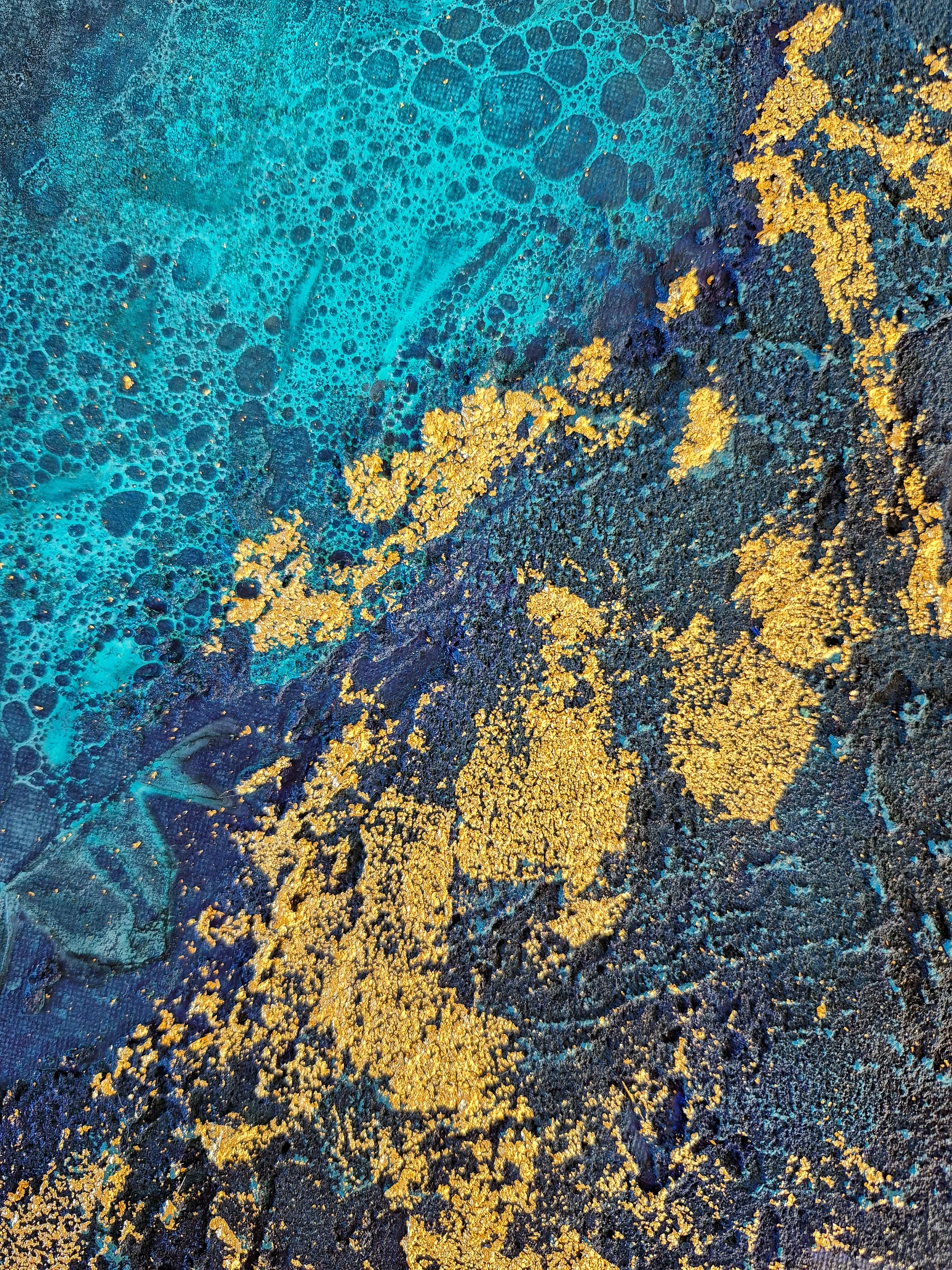 ​Modern living room featuring a large circular abstract wall art piece with deep teal, navy, and gold leaf textures.