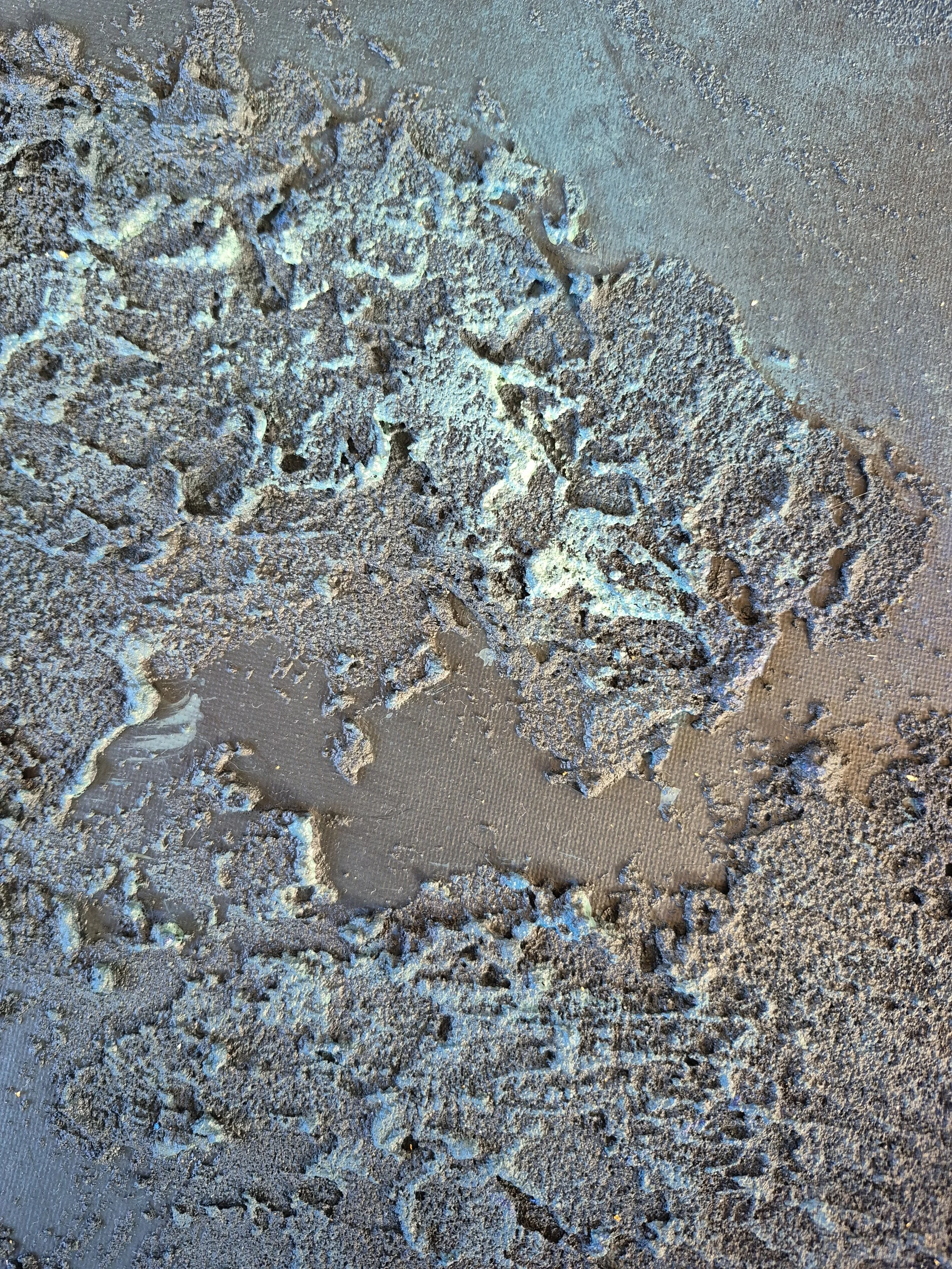 ​Modern living room featuring a large circular abstract wall art piece with deep teal, navy, and gold leaf textures.