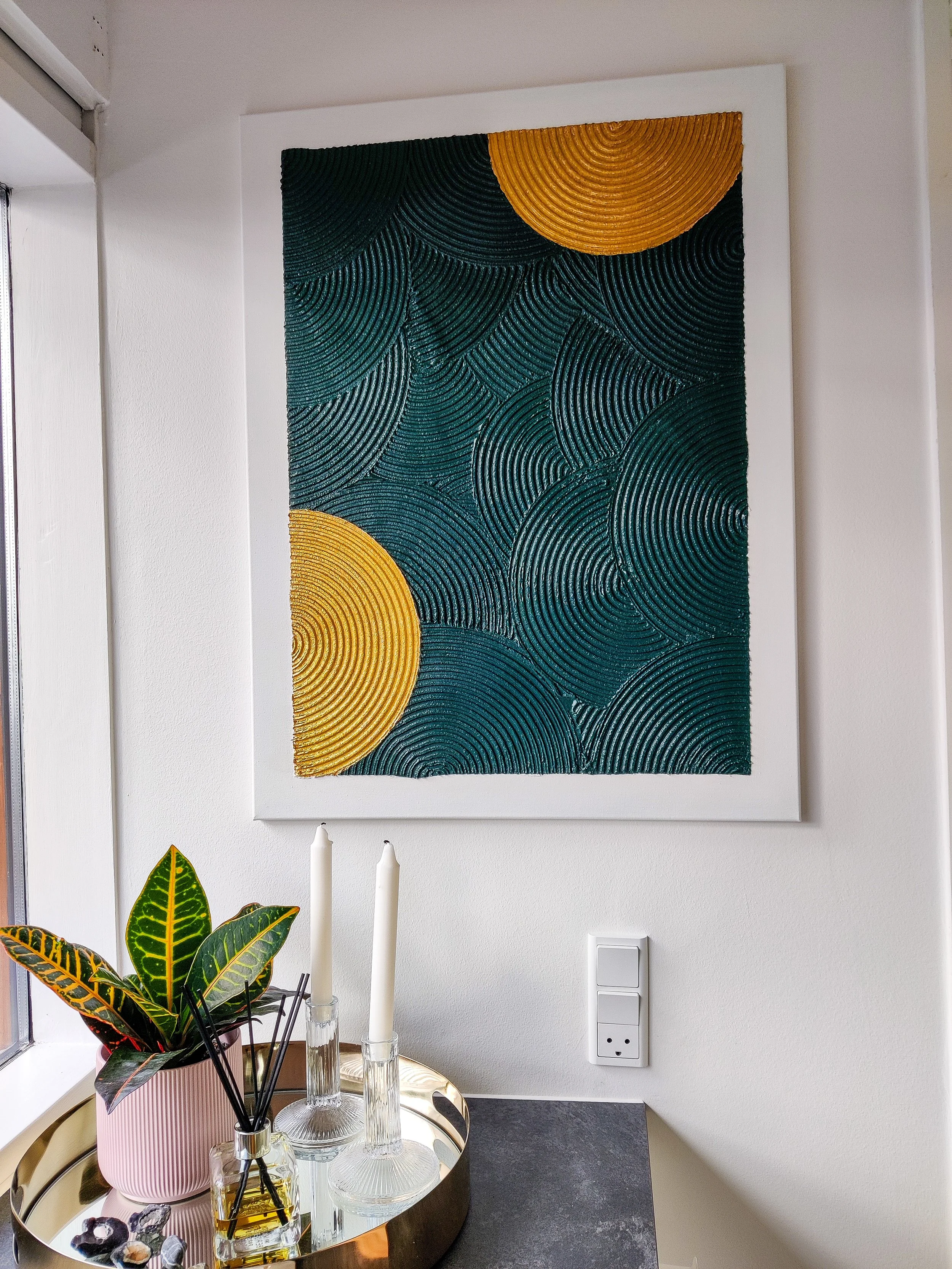 Abstrakt maleri med cirkulær tekstur i mørkegrøn og guld, perfekt til en skandinavisk indretning.