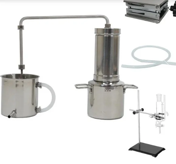 Laboratory distillation apparatus with metal and glass components, including a boiling flask, condenser, and collection vessel.