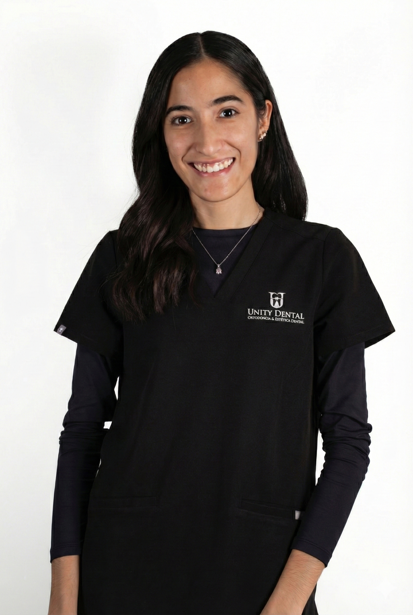 Woman sitting on a bench in a room, illuminated by sunlight casting shadows on the wall behind her.