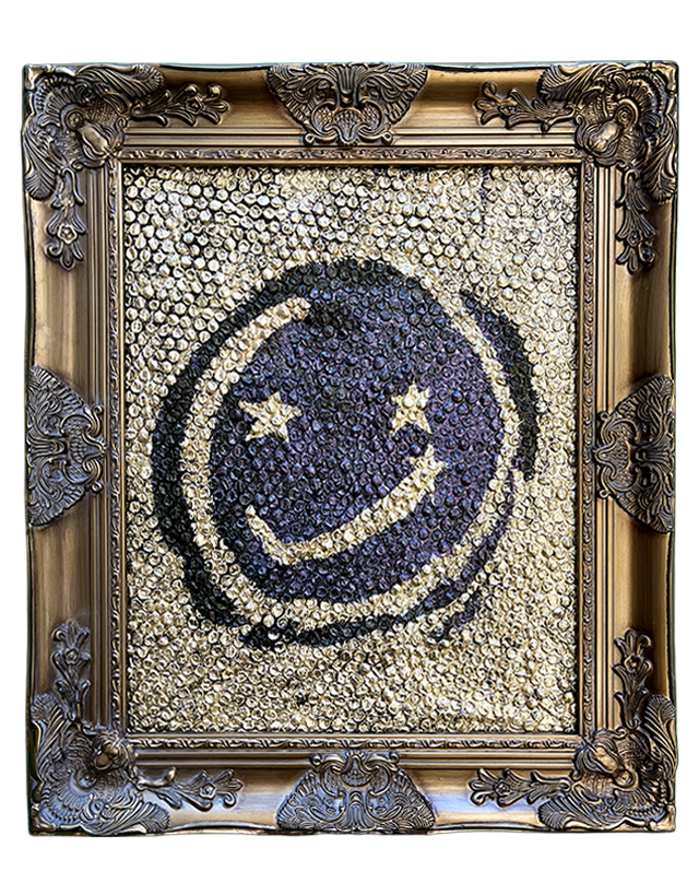 A framed artwork featuring a smiley face with stars for eyes, made from numerous small, shiny objects with a decorative ornate frame.