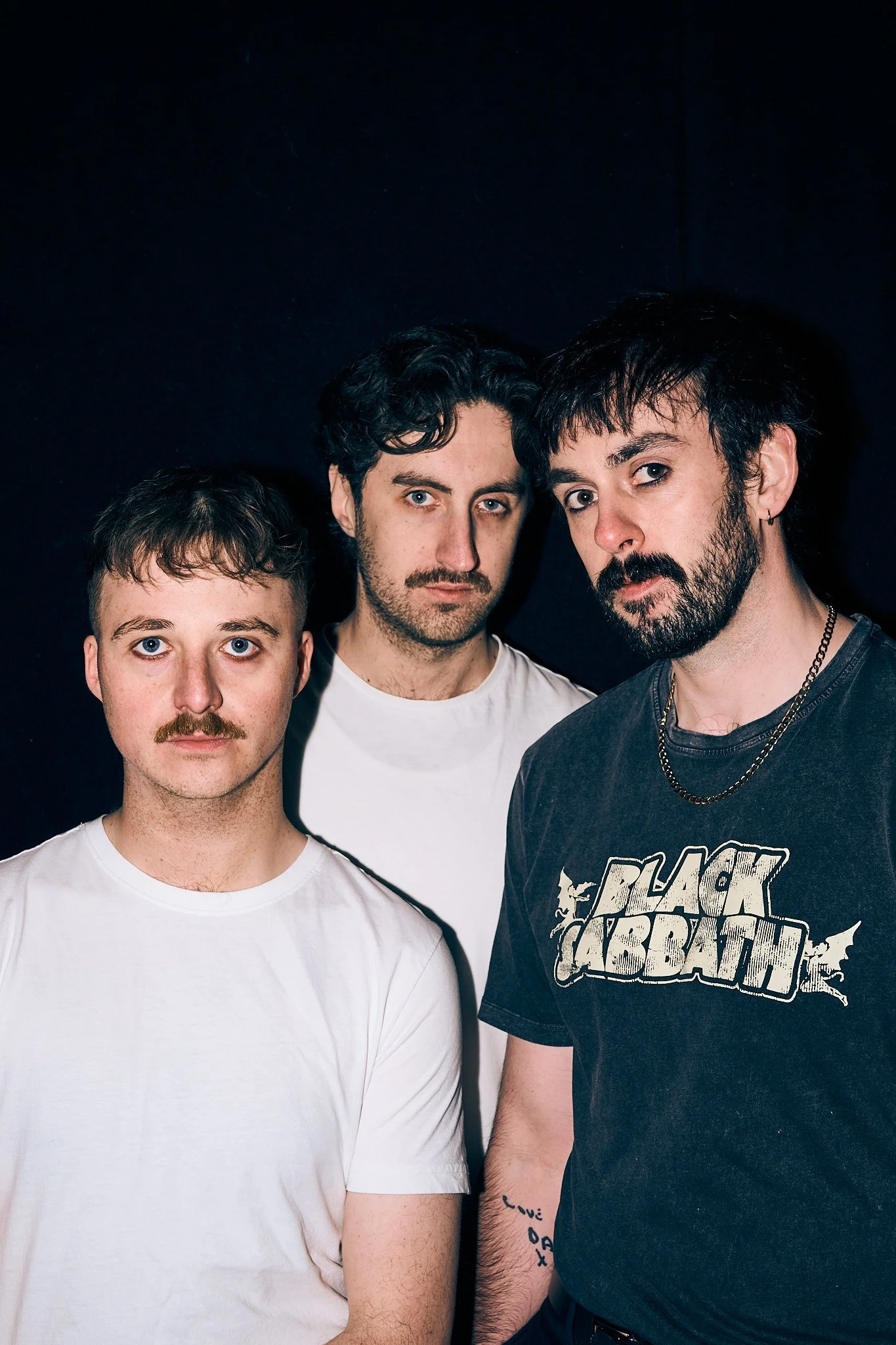 People Laughing band members standing together for a promotional photo.