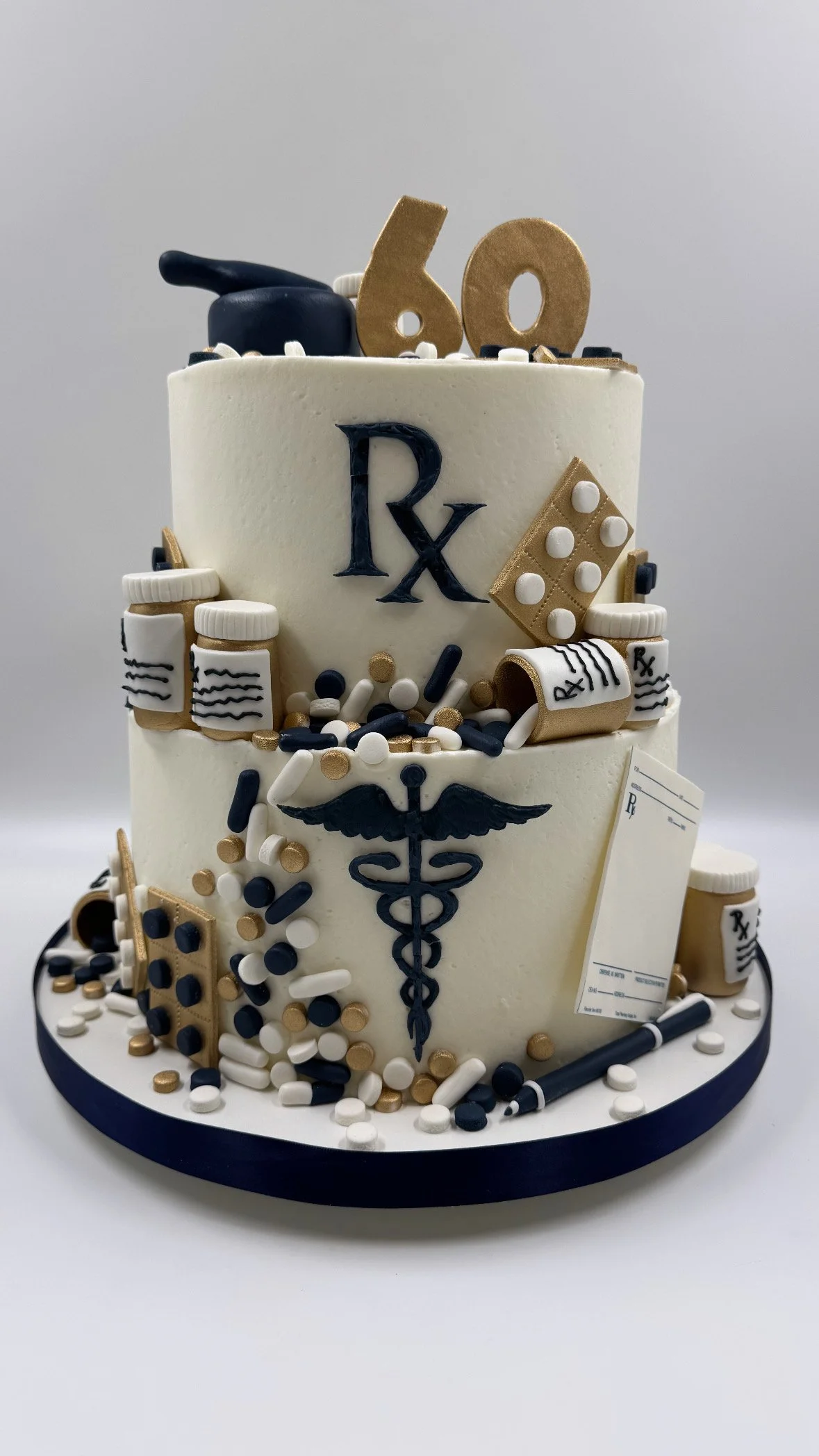 Medical-themed birthday cake decorated with medication bottles, prescription pad, and pharmacy symbols.