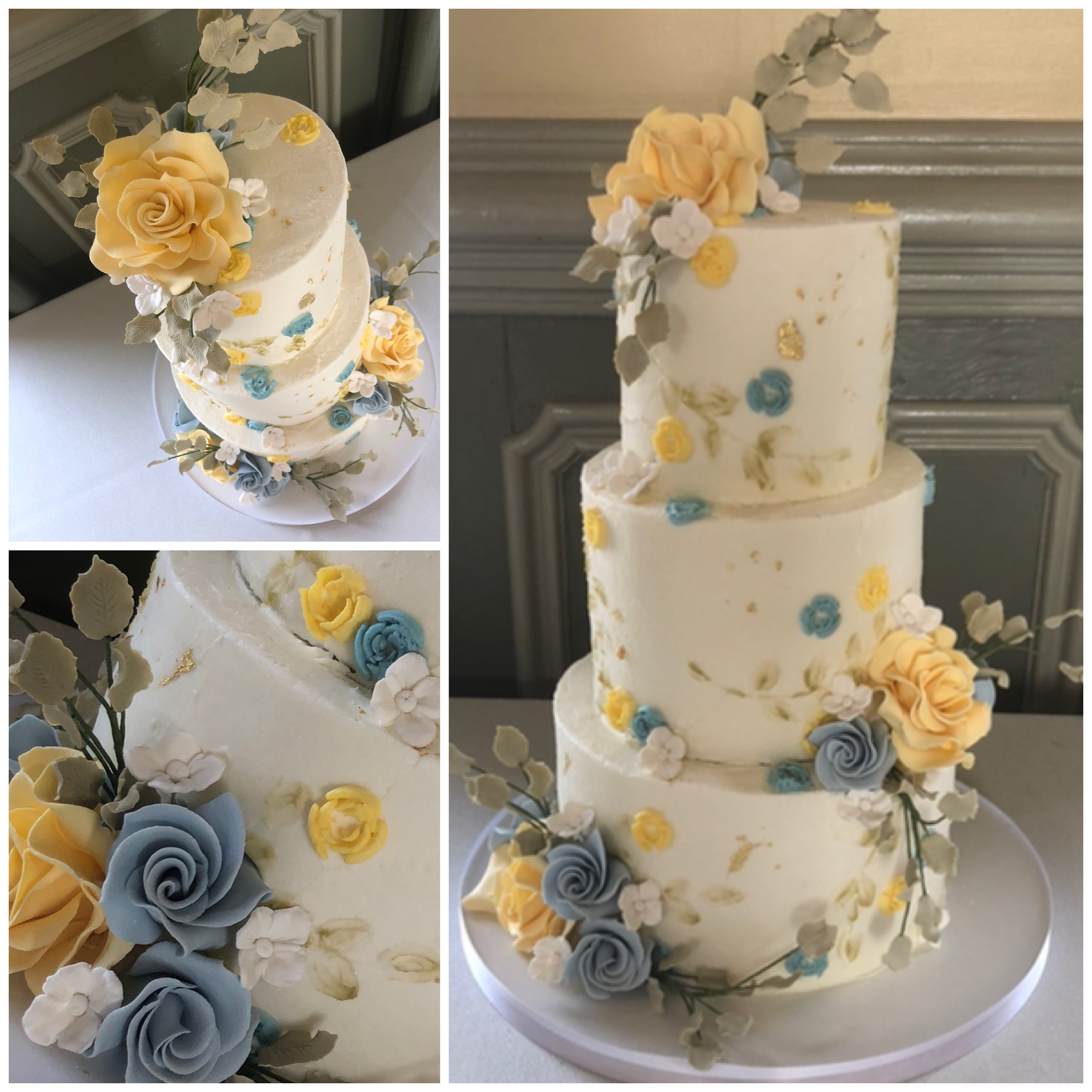 Three-tier white wedding cake decorated with yellow, blue, and white fondant roses and leaves.