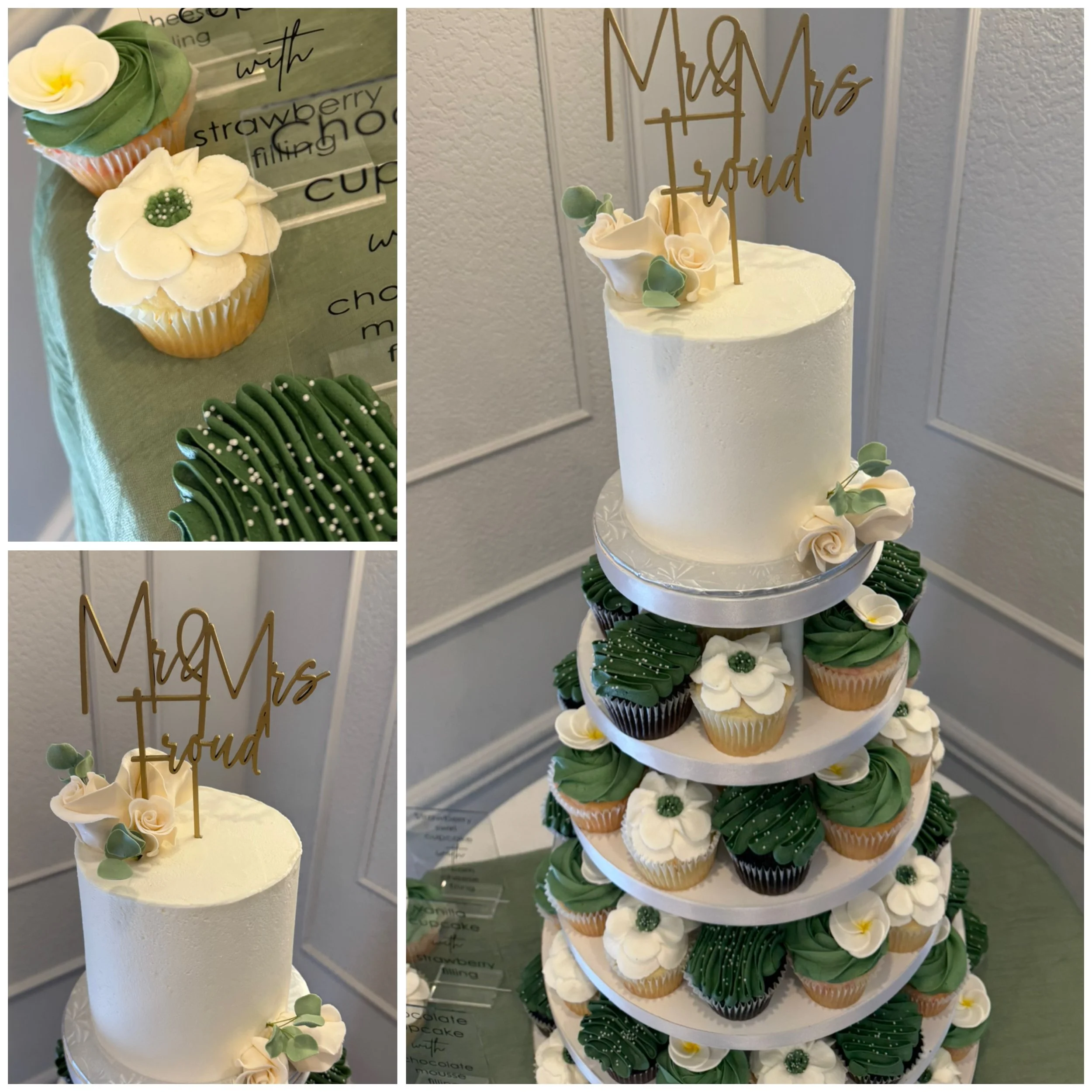 A tiered cupcake display with a white wedding cake on top and cupcakes decorated with green and white icing flowers and leaves. 