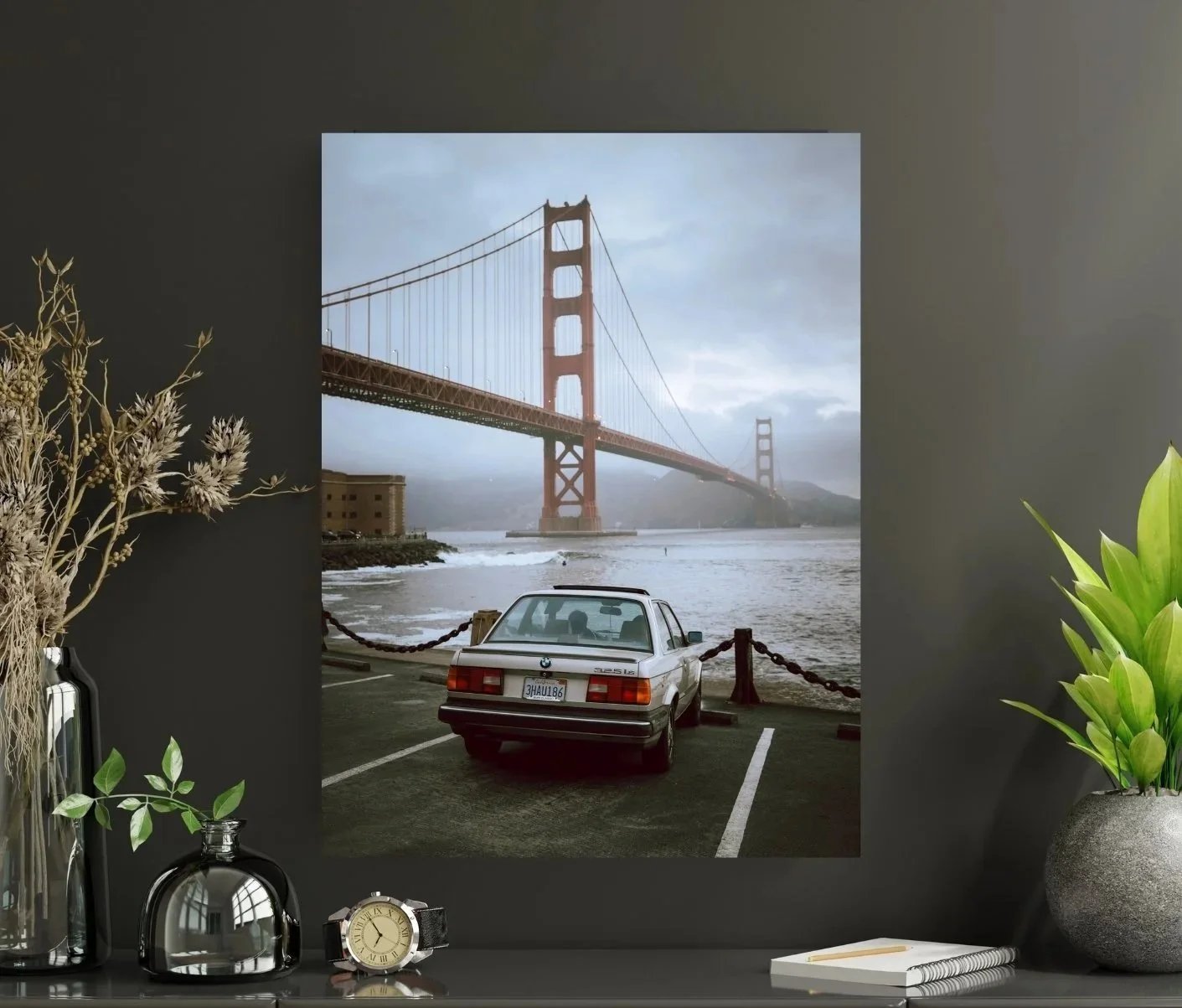 Car parked on the road to Fort Point with the Golden Gate Bridge in the background over water on a gloomy, overcast day.
