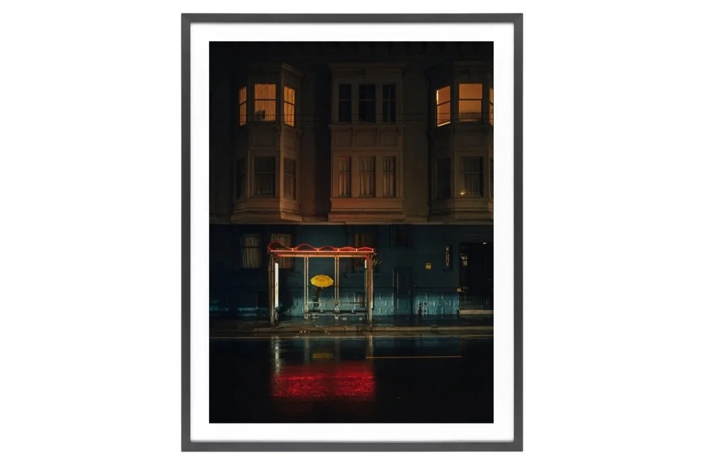 Yellow Umbrella in between bus stop. Night photo.