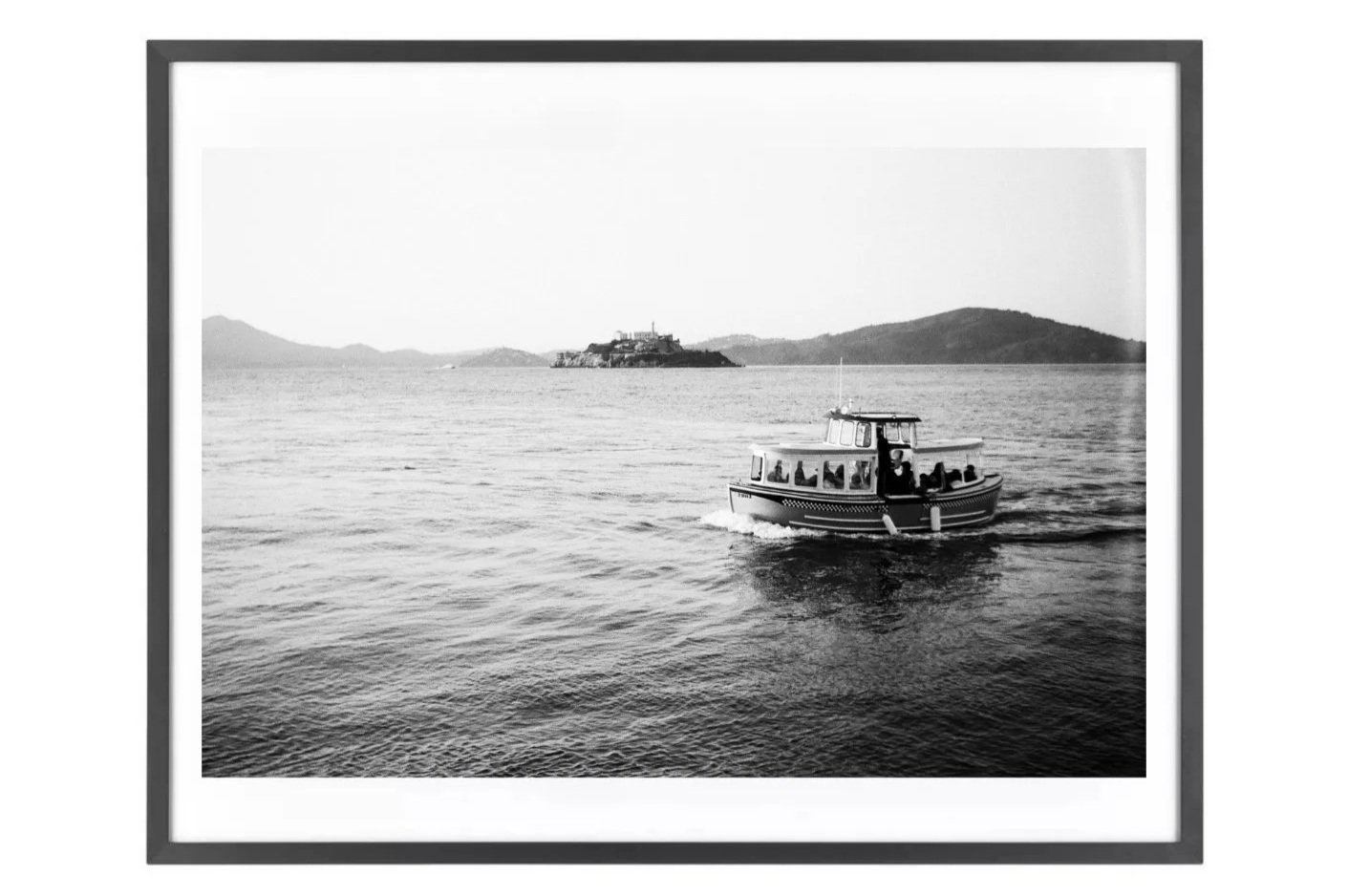 Black-and-white wall art print of a small boat on San Francisco Bay with Alcatraz and Angel Island.