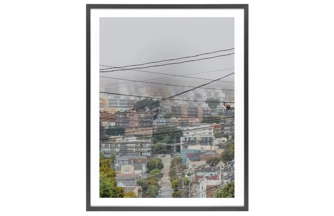 Hills with houses behind fog