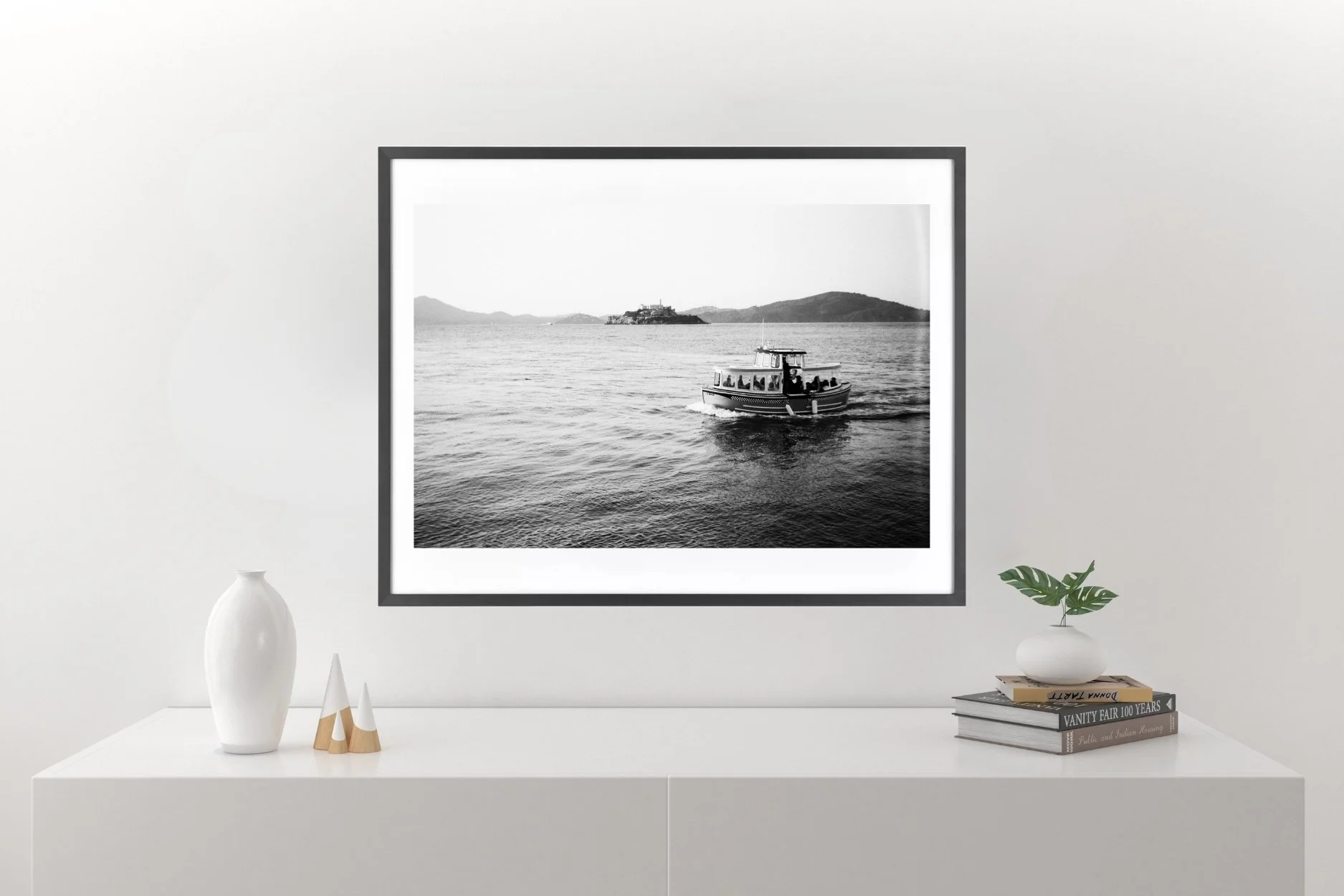Black-and-white wall art print of a small boat on San Francisco Bay with Alcatraz and Angel Island.