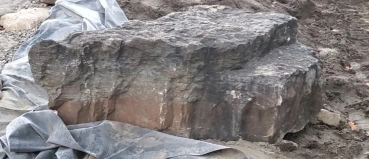 Rock-lined koi pond build in New York with small waterfall