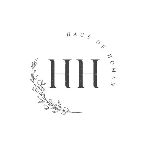 Black and white logo with the text "H H" in large font, surrounded by the words "Haus of Homan" in a circular pattern and decorative floral elements.