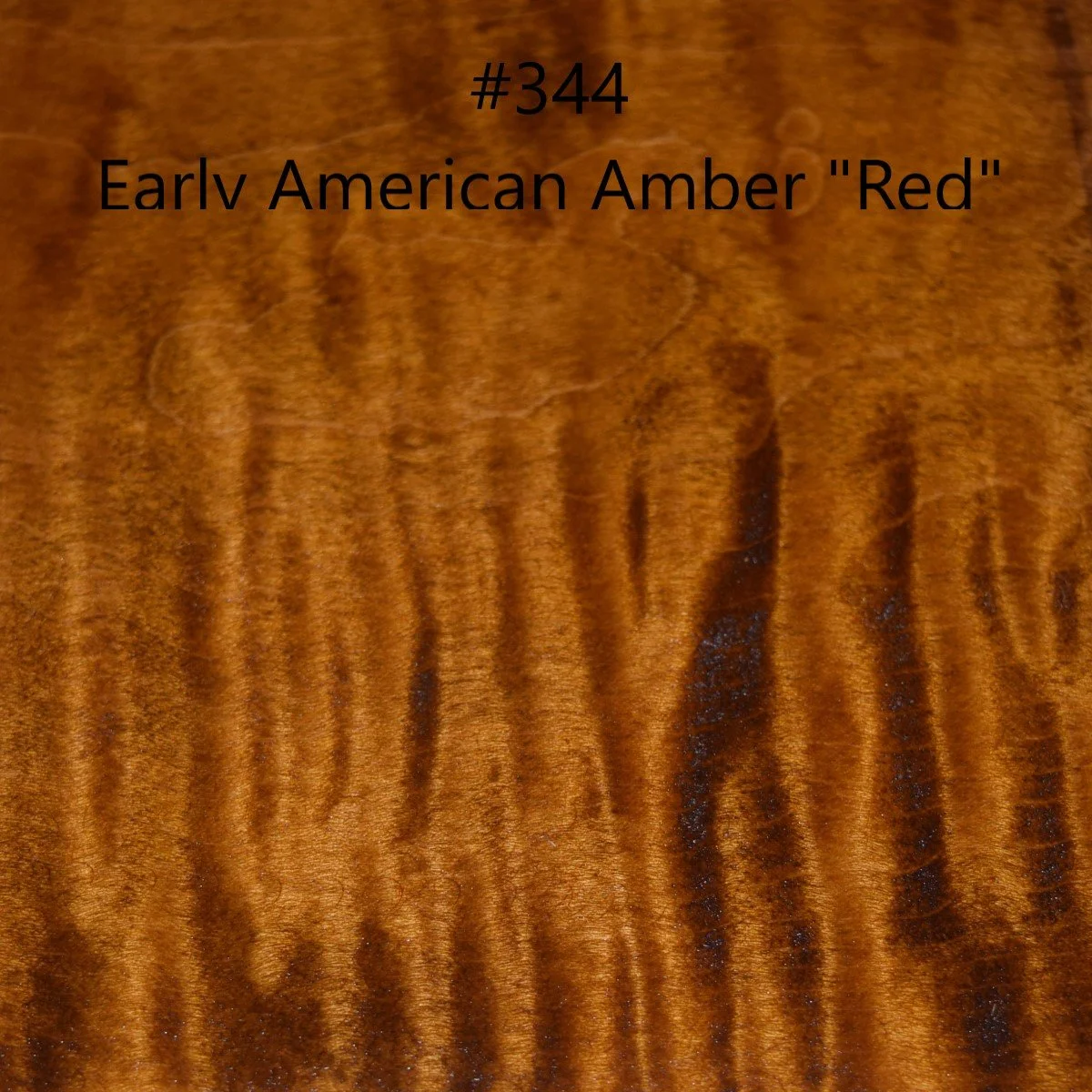 Photo of a wood surface with black text reading '#344 Early American Amber 'Red'.