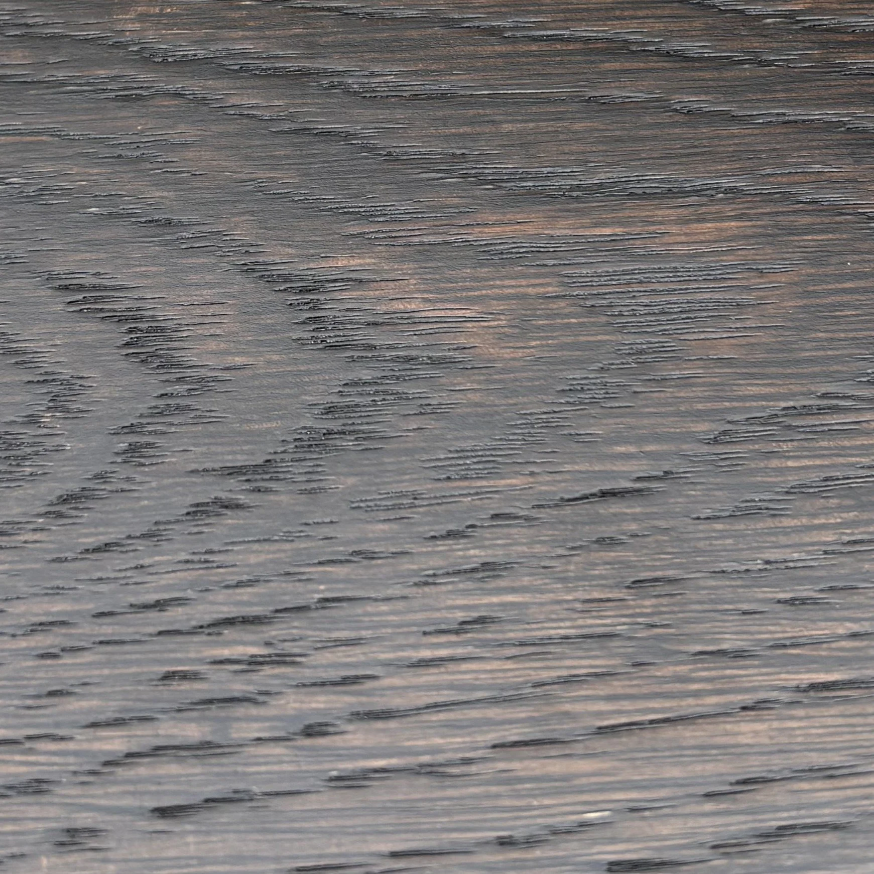Close-up photo of a wooden surface with visible grain and texture.