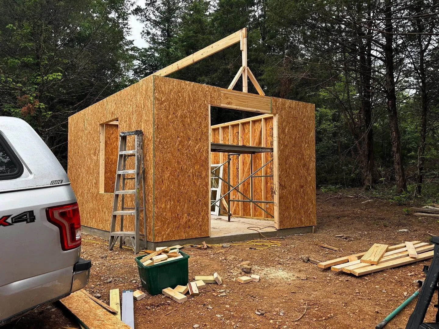 I am tired after 7 hrs of framing my little cottage for my dust collection, compressor and wood storage. Not used to working outside in fresh air and sun beating down on me. 12x14 building. Will have gabled ends and a barn door and window.