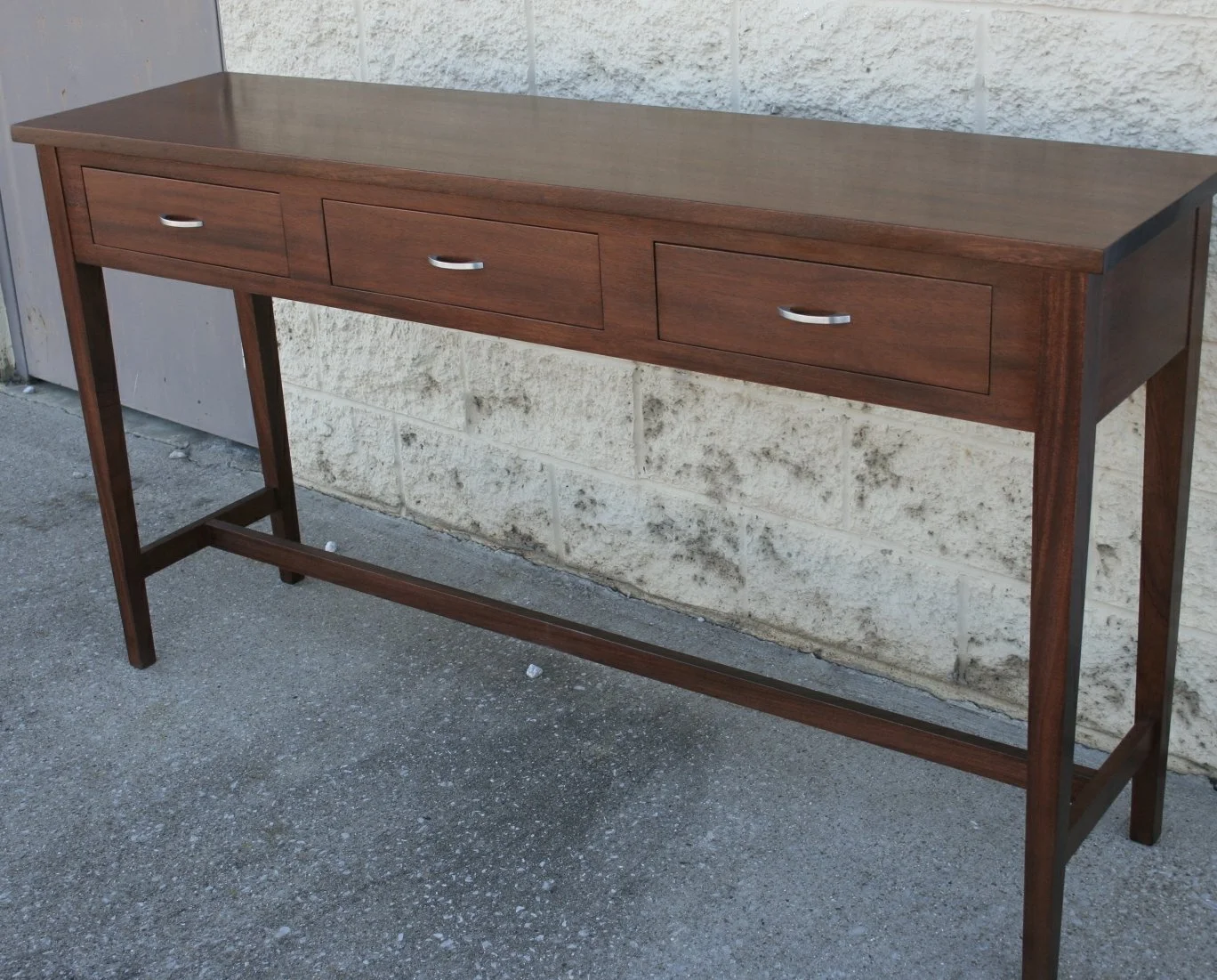 shaker sofa table made from walnut three drawers and shelf